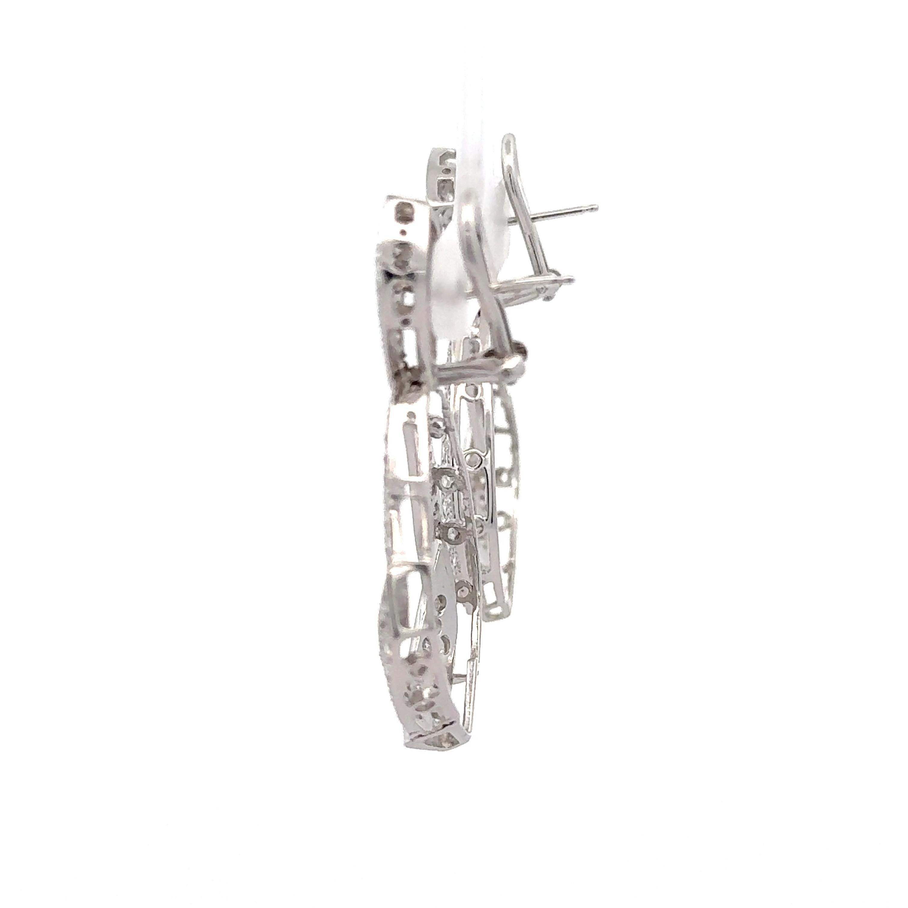 5.1 carat pave set diamond open drop shape clip on drop earrings in 14k white gold.

Striking yet sophisticated, these 14K white gold drop earrings feature a stunning arrangement of natural diamonds in a modern clip-on design—perfect for effortless