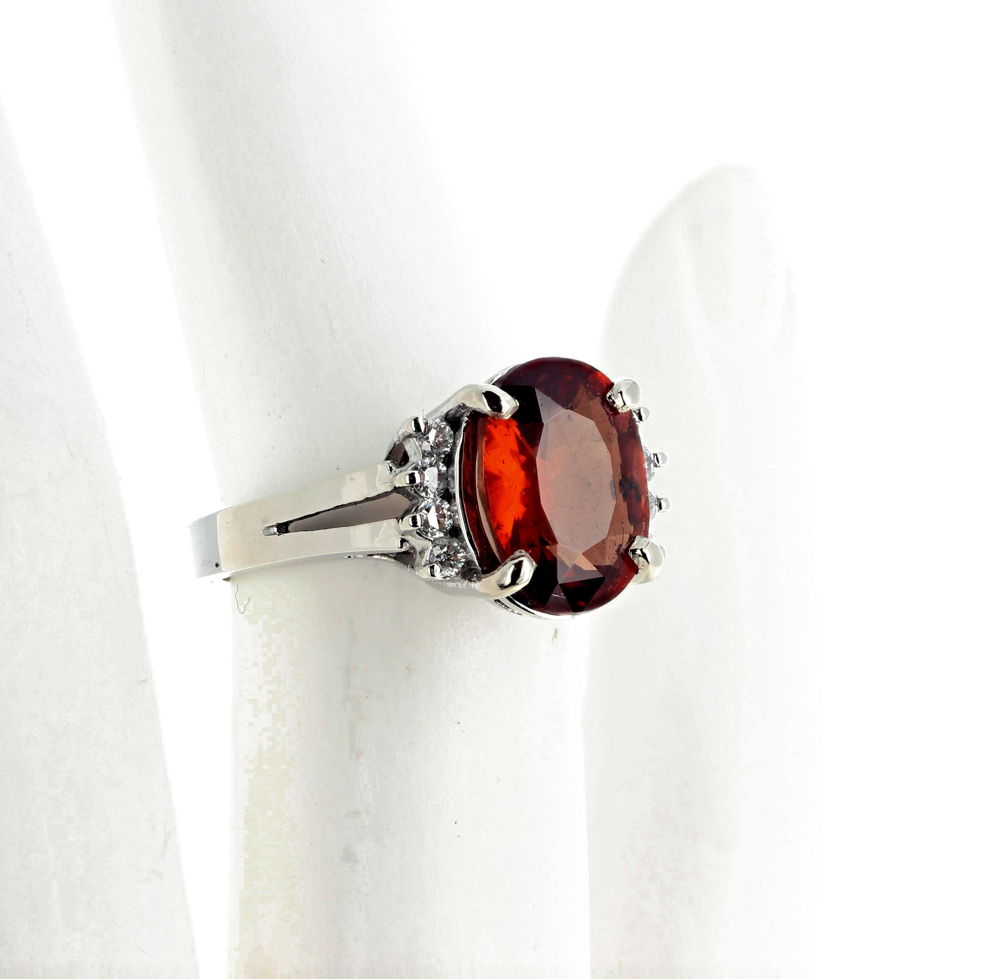 Bright unique glittering Reddish (slight tinge of orangy glitter) 5.1 carats of natural Zircon enhanced with 0.22 carats of white diamonds set in a 14K white gold ring size 7 (sizable FOR FREE).  The Zircon is a 9 x 7 gemstone. 