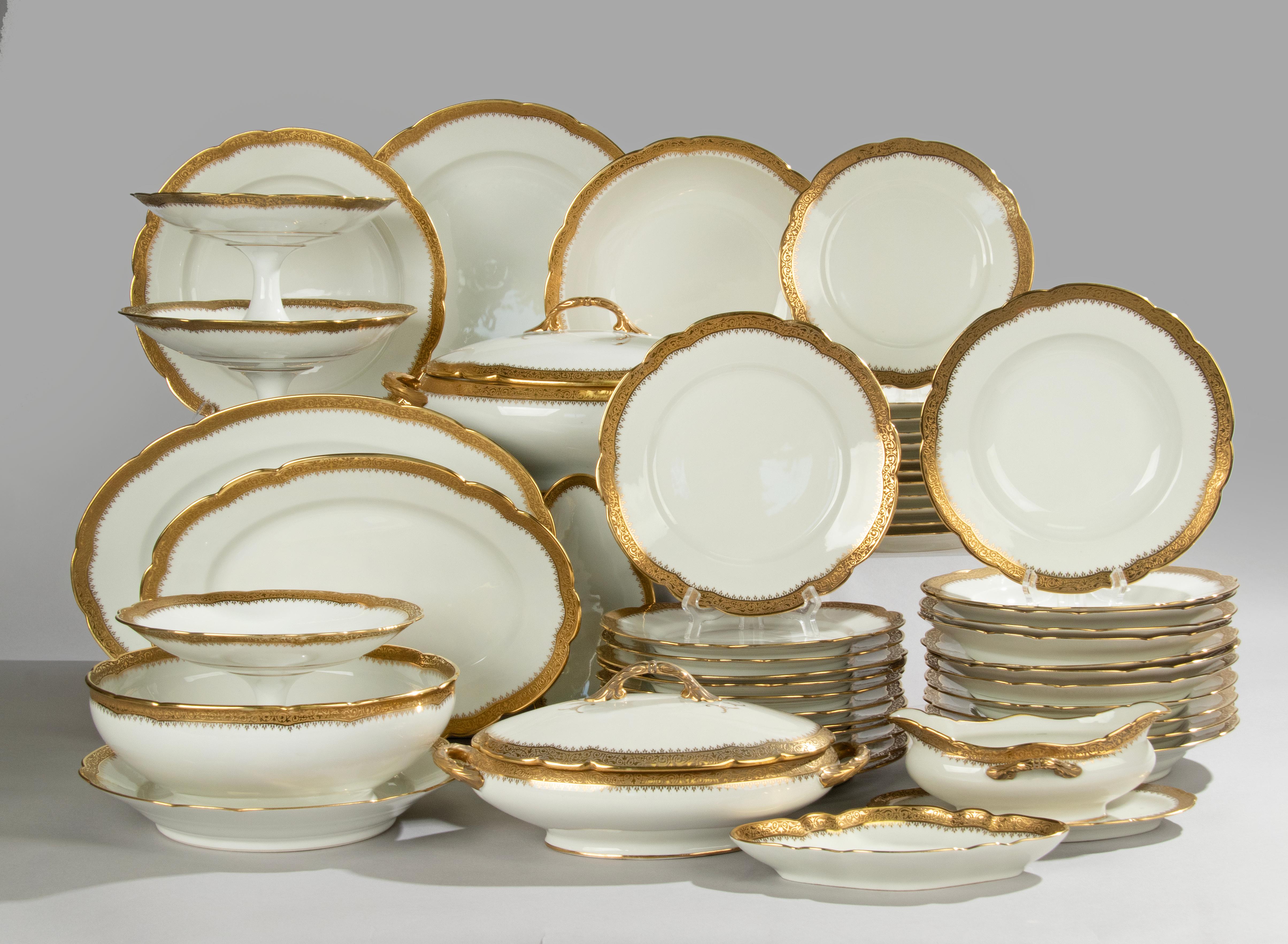 A beautiful porcelain table service for 12 people, presumably from the French brand Limoges. The service contains many serving pieces.
The service is beautifully decorated with inlaid gold edges.
The plates and bowls are all marked with a mark of A.