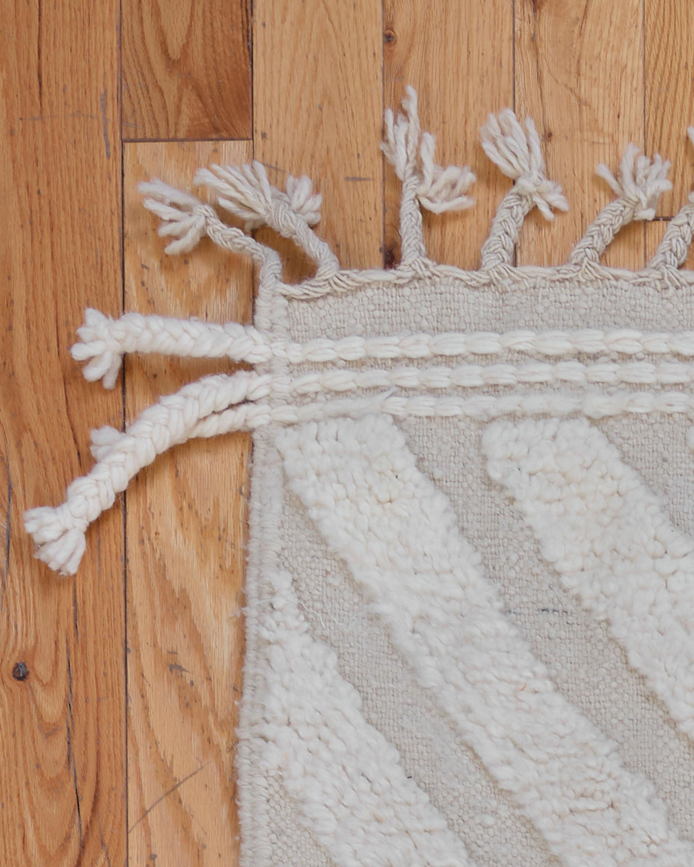The Betonica rug is a luxurious Beni Ouarain piece, handwoven by skilled Berber artisans in the Atlas Mountains of Morocco. Made from 100% natural sheep’s wool, this thick pile rug offers exceptional comfort and warmth underfoot. Featuring a