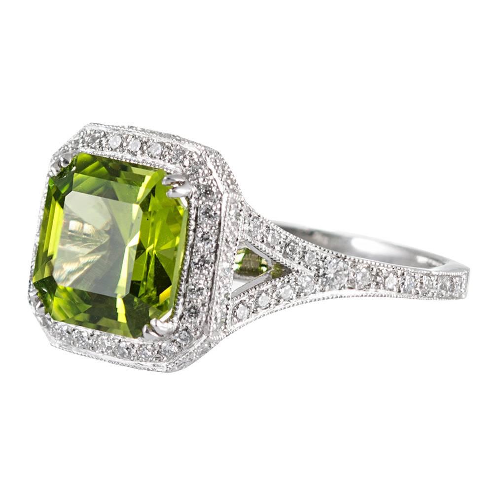 A clean and classic design centered upon a 5.10 carat peridot, framed in an intricate diamond mounting. Peridot has a particular allure and the color looks well with any palette. In total, there are 62 white brilliant diamonds that weigh .62 carats.