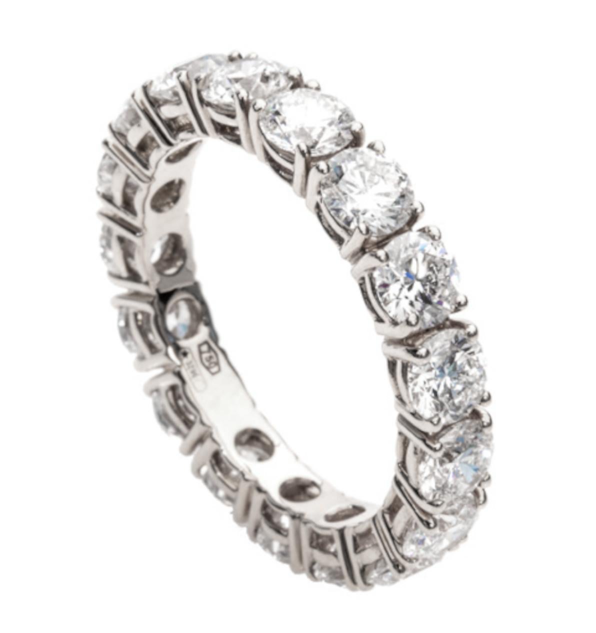 Indulge in the epitome of elegance with our captivating 5.10 Carat Round Brilliant Cut Diamond Eternity Band Ring, meticulously crafted in the finest 18K White Gold. This extraordinary piece is a symphony of sophistication, harmonizing the