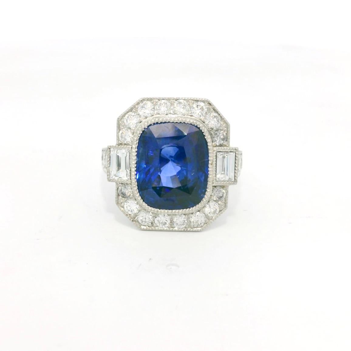 Art Déco inspired sapphire and diamond ring. 

The ring is set with a center blue Ceylon cushion sapphire of 5.10 carats. The blue is very rich and intense. 

On the sides of the sapphire we have 2 baguette shape diamonds and 22 brilliant cut