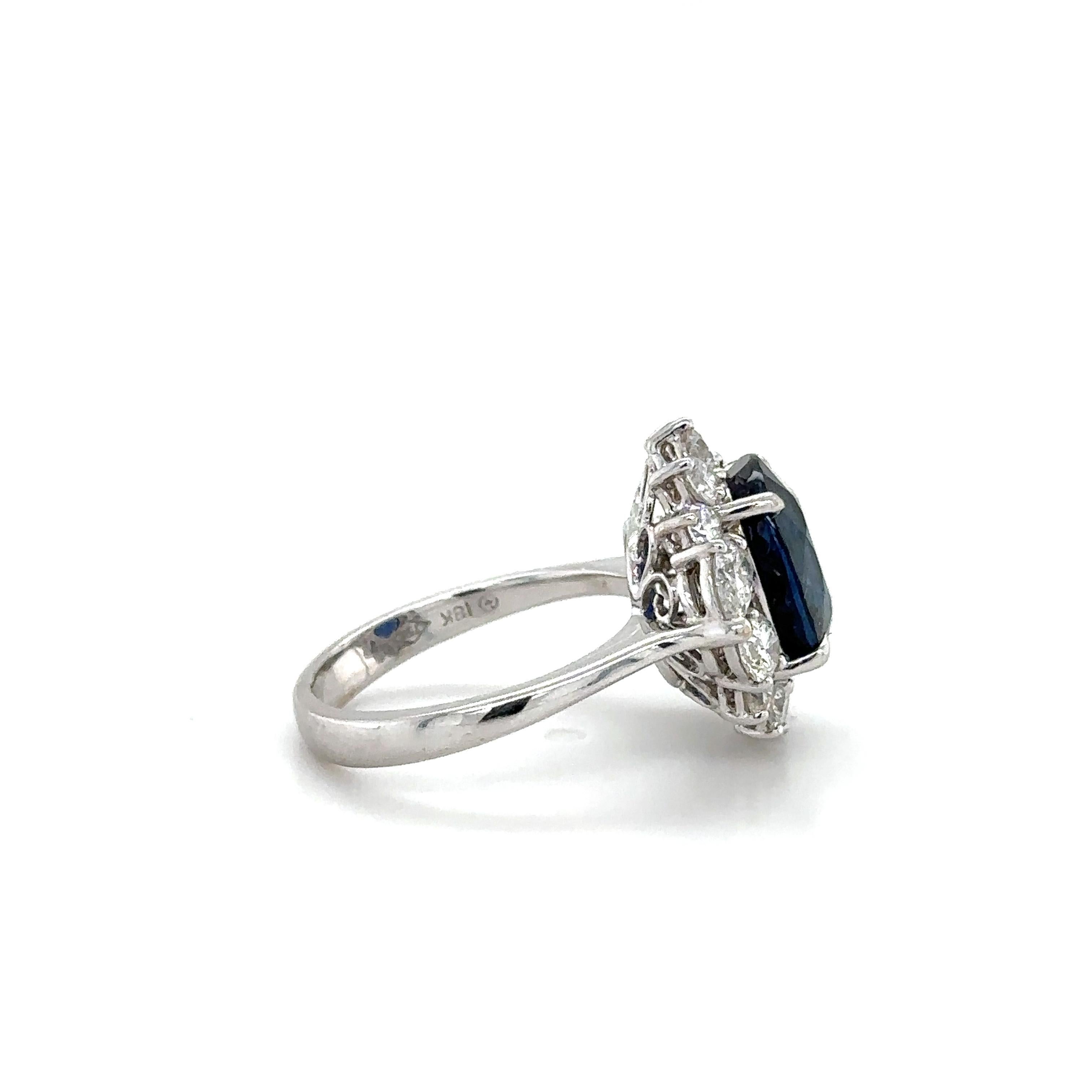 A stunning exquisite ring set in 18k white gold, showcasing a remarkable 5.10ct. oval-cut Sapphire encircled by a total of 0.56ct pear-shaped diamonds and 0.63ct round brilliant cut diamonds.

The lustrously stunning Sapphire is graded as 