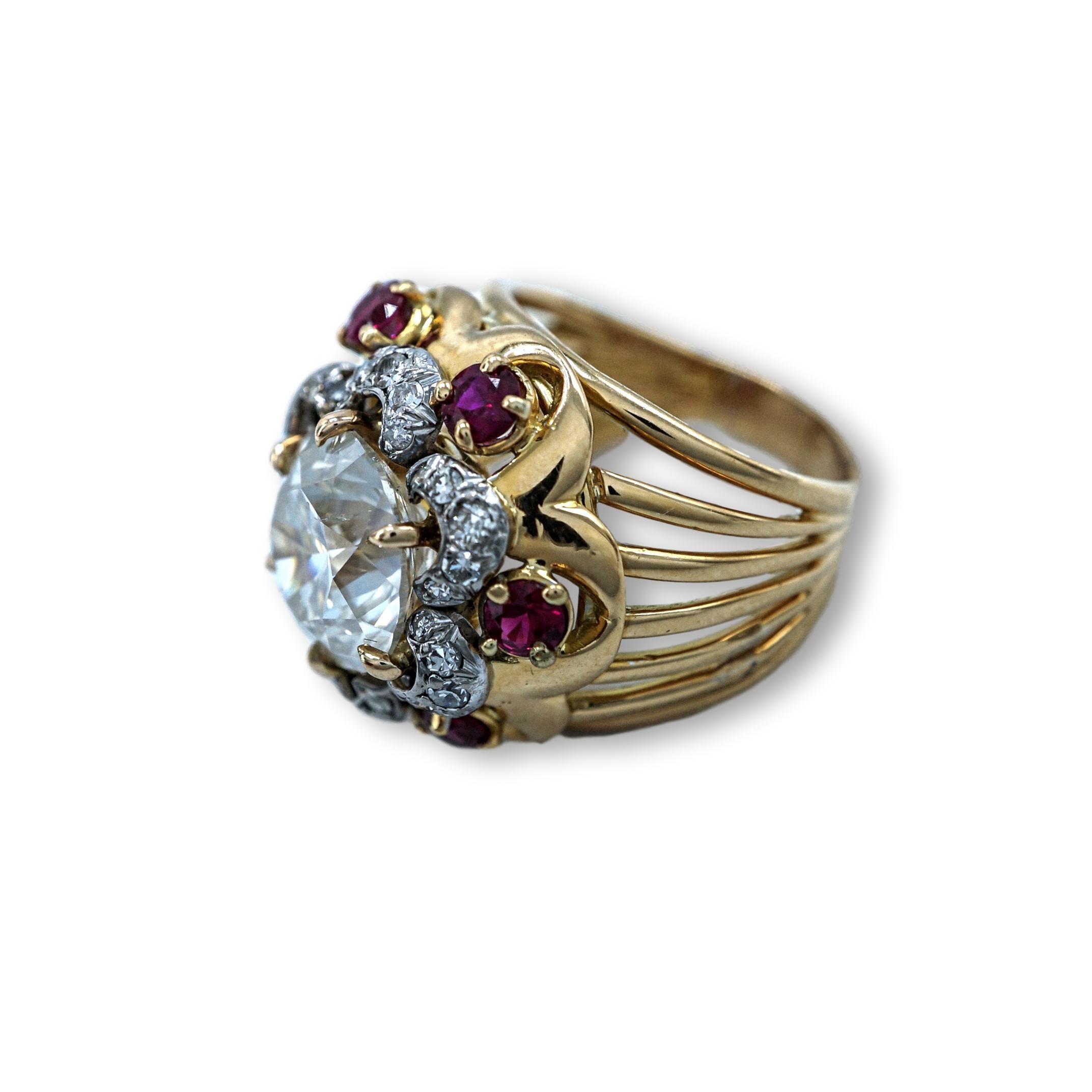 This 1950's Diamond and Ruby Cocktail Ring comes with a GIA Certificate and has a total weight of 12 Grams. This ring features 6 beautiful colored rubies each 0.60 points, embedded diamonds are K-colored, this piece is sized 5.75.