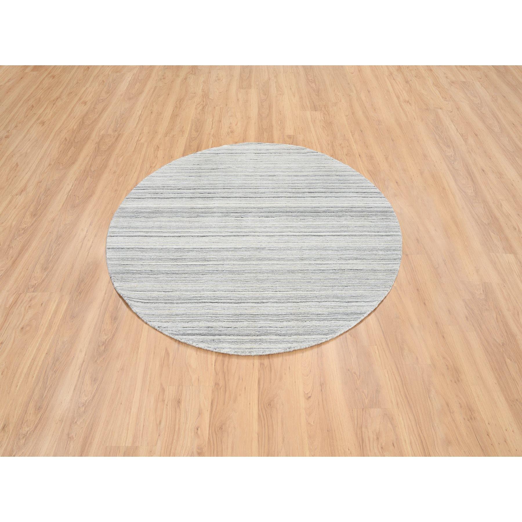 This is a truly genuine one-of-a-kind Platinum Gray and Cream, Plain Hand Loomed Undyed Natural Wool, Modern Design Thick and Plush, Round Oriental Rug. It has been Loomed for months and months in the centuries-old weaving craftsmanship techniques