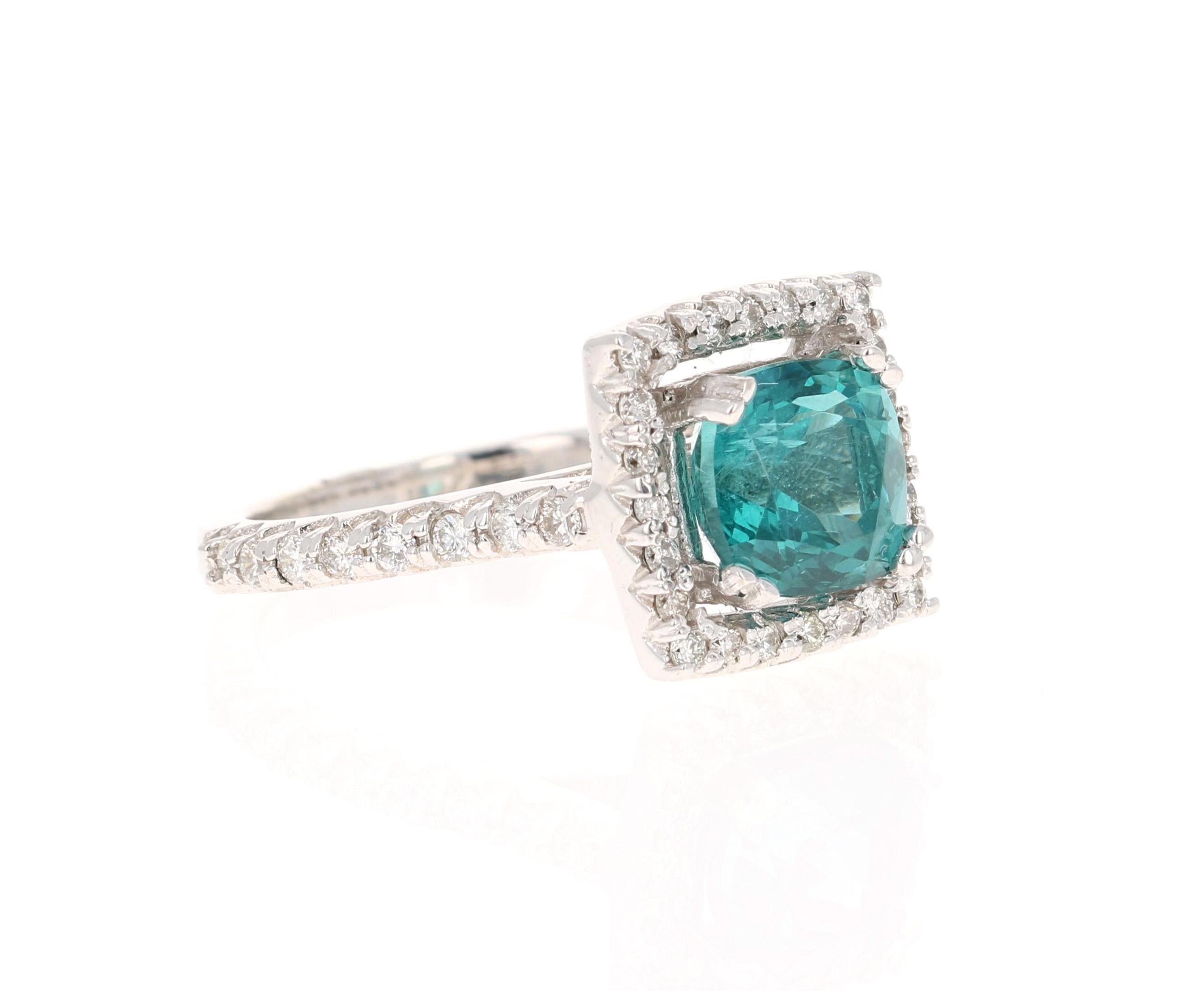 This ring has a 4.67 carat Apatite in the center of the ring and is surrounded by a halo of 34 Round Cut Diamonds that weigh 0.44 carat. The clarity of the diamonds are VS and the color is H. The total carat weight of the ring is 5.11 carats.  

The