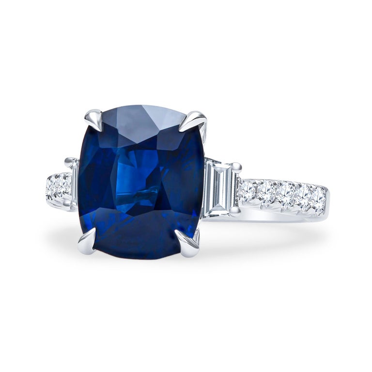 Gorgeous 5.11 carat cushion cut blue sapphire (GIA certified) with two perfectly matched step cut trapezoids with 0.40 carats total weight, and 0.35 carats total in round brilliant cut diamonds. This piece was custom crafted by our in-house master