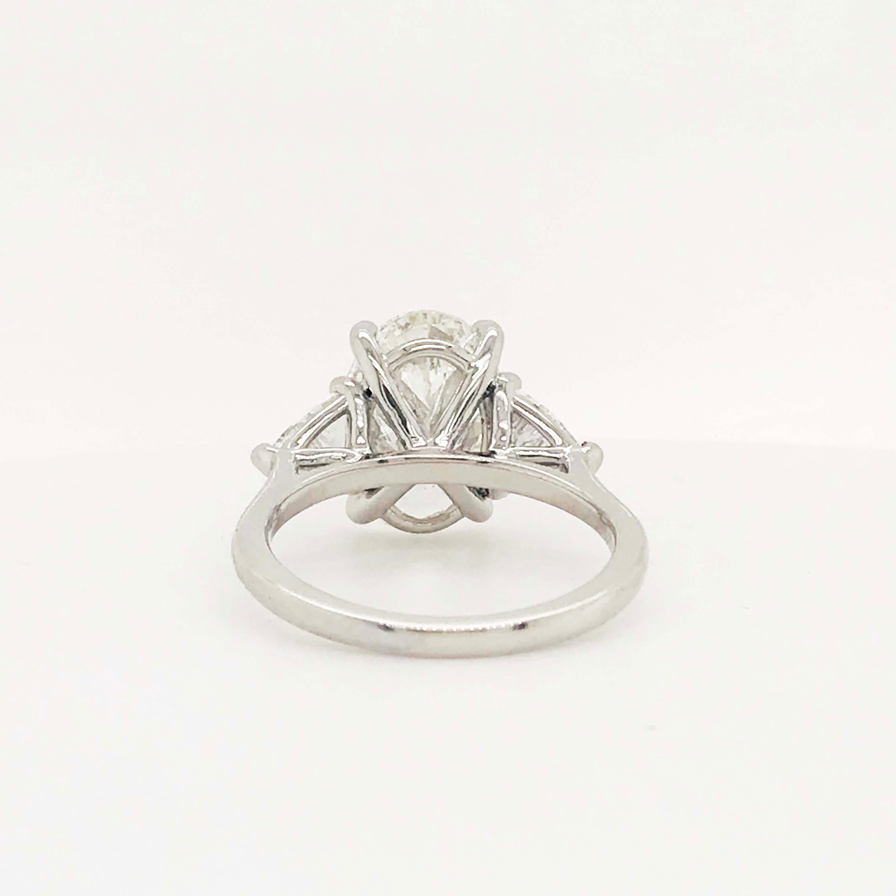 Modern 5.88 Carat Oval Diamond Three-Stone Platinum Engagement Ring Trillion Diamonds