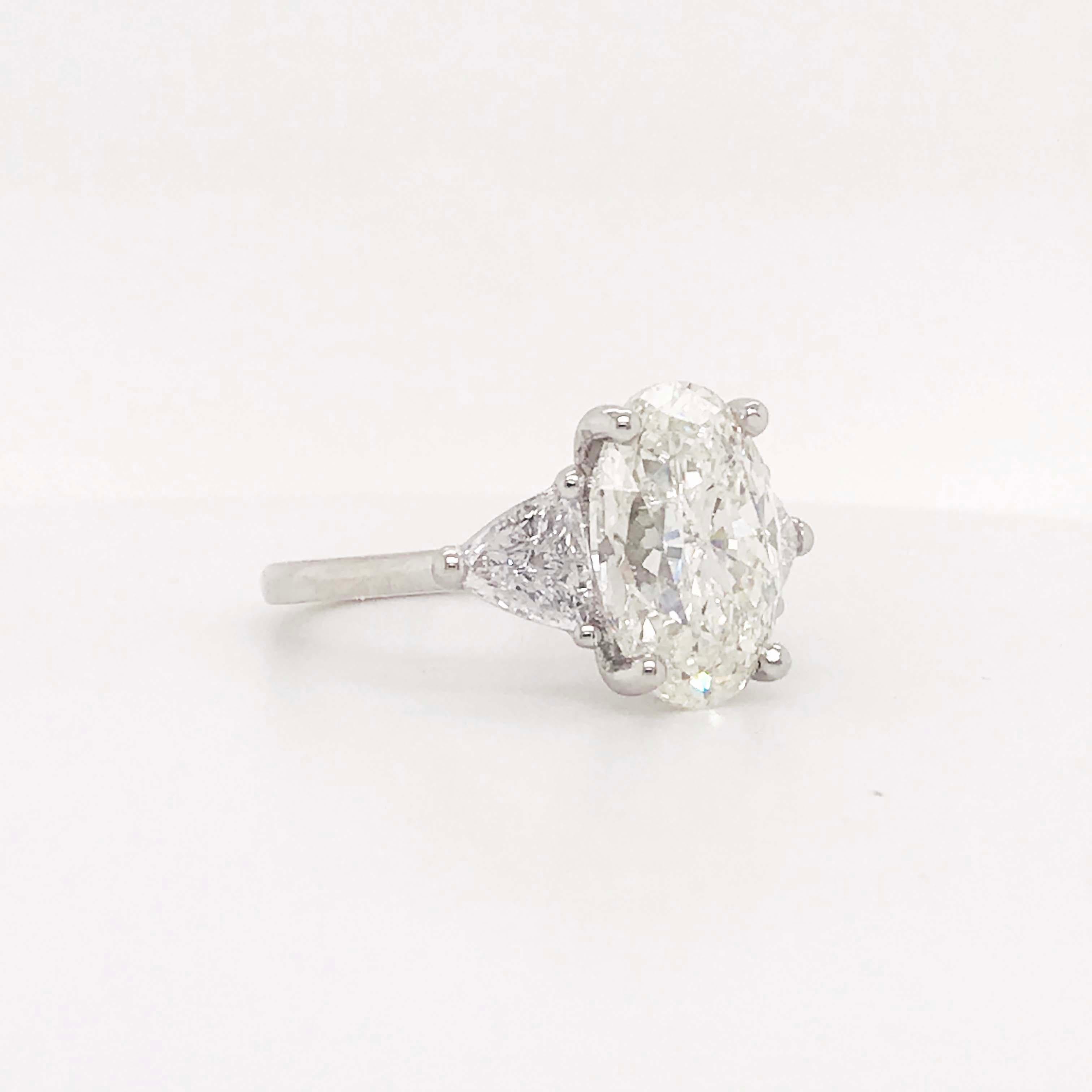 5.88 Carat Oval Diamond Three-Stone Platinum Engagement Ring Trillion Diamonds In New Condition In Austin, TX