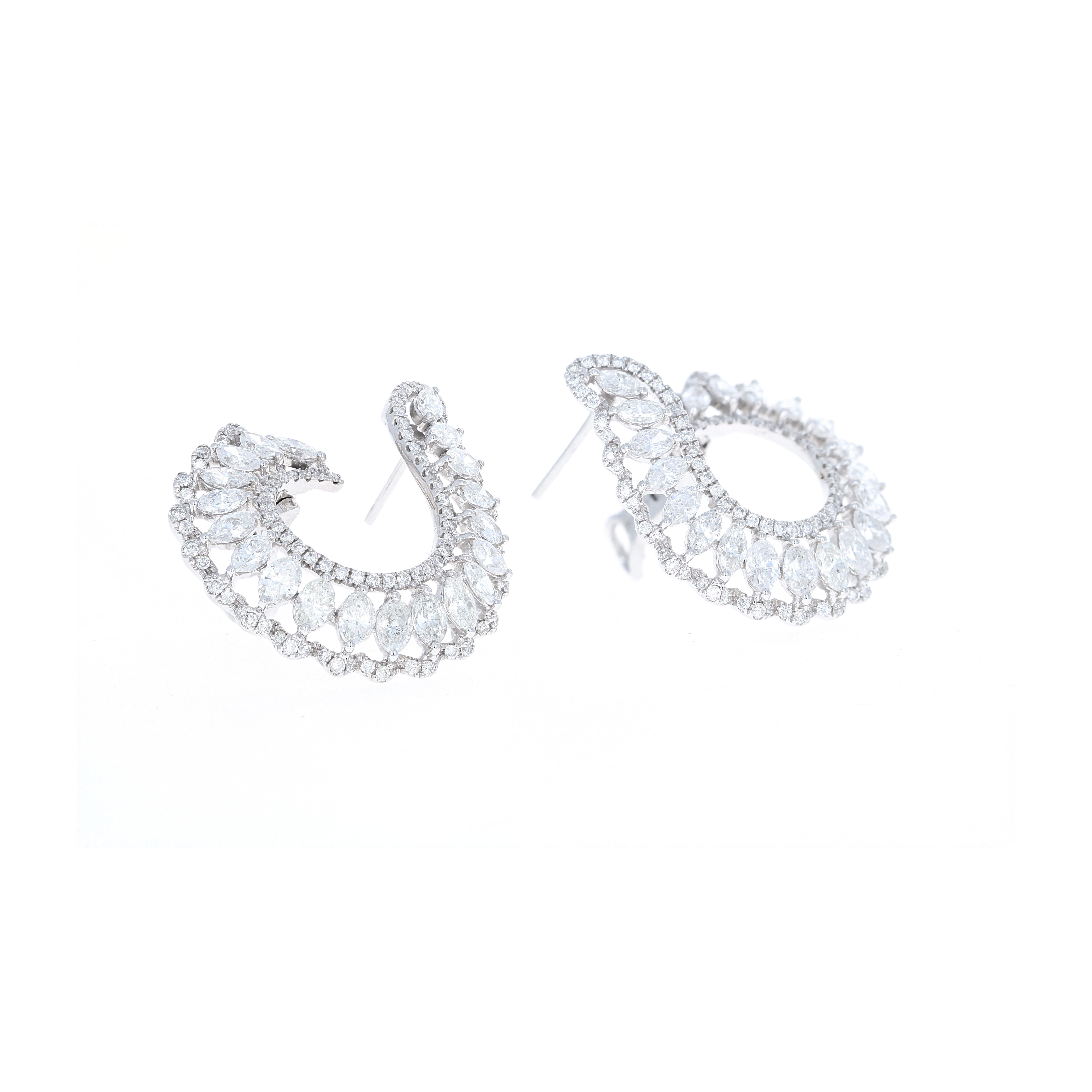 These stunning 18 karat white gold diamond hoop earrings are beautifully made and easy to wear. They have a total weight of 5.11 carats in diamonds. The diamonds are round and marquise shape. There are 206 round brilliant diamonds and 40 marquise