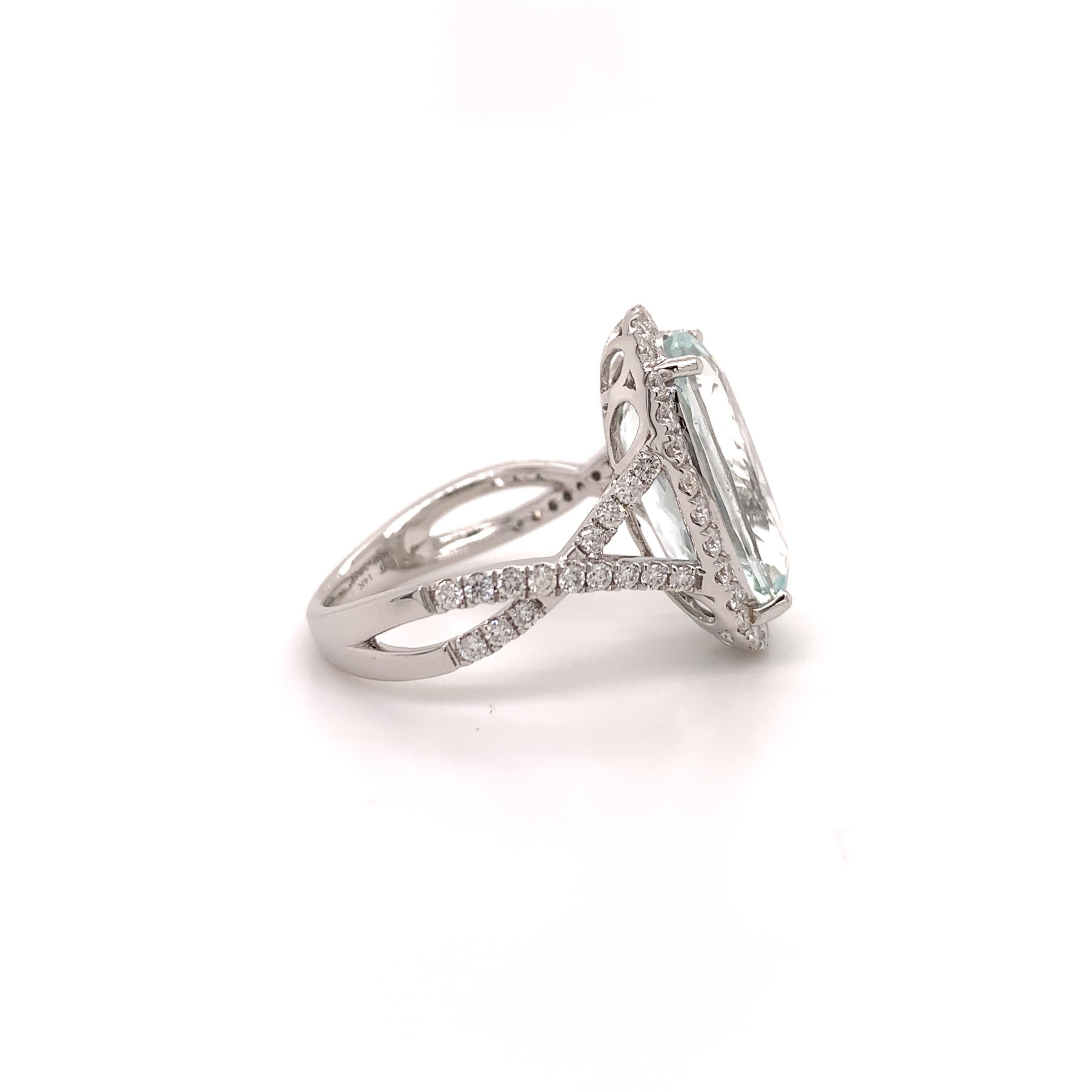 Stunning aquamarine cocktail ring. High brilliance, transparent, oval faceted, lively light sky blue 5.12 carats natural aquamarine mounted in high profile open basket, accented with a round brilliant cut diamond on the split shank and halo design.