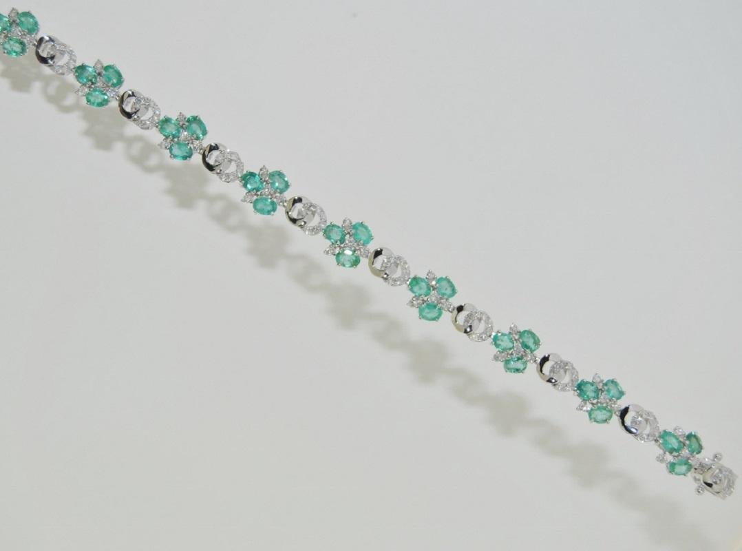 14K white gold link bracelet featuring 5.12 carats of oval Emeralds, 1.39 carats of round brilliant white diamonds and box clasp closure with figure 8 safety.
Size: length 7 inches, width 0.25 inches