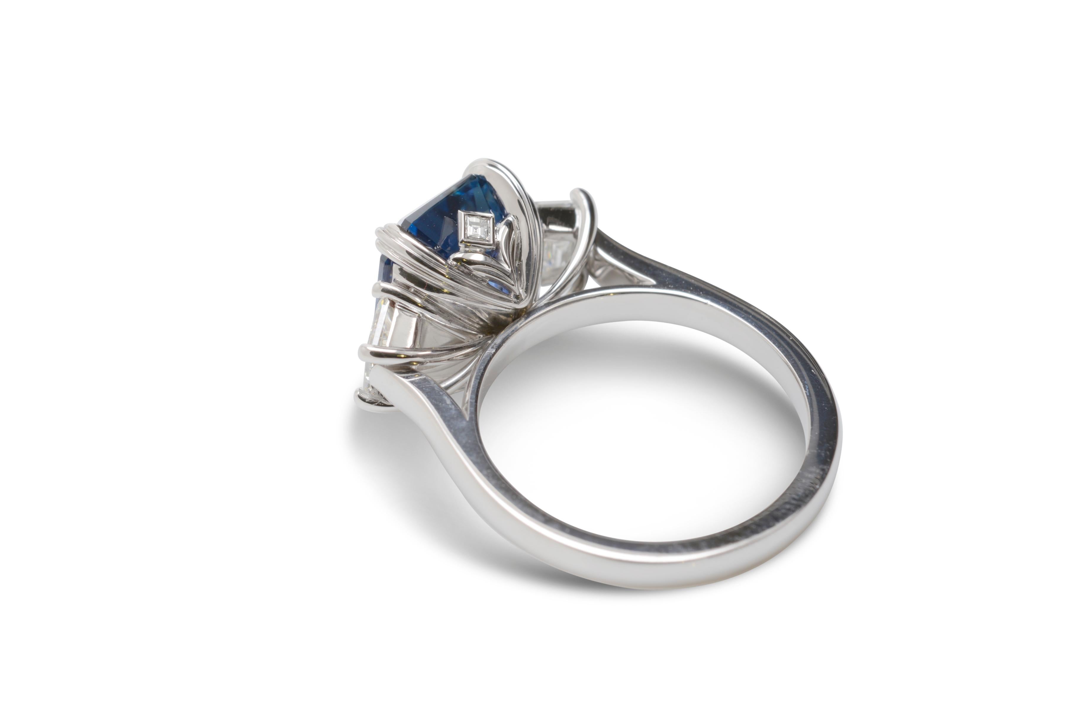 Its a very rare occasion that the opportunity to own a natural, unheated, vivid blue, emerald cut sapphire of 5.12 carats arises. This truly special gemstone has been handcrafted by Nicky Burles into a stunning three stone ring in 18 karat white