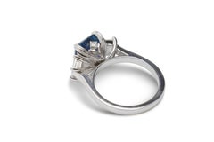 5.12 Carat Natural Emerald Cut Vivid Blue Sapphire and Diamond Three-Stone Ring