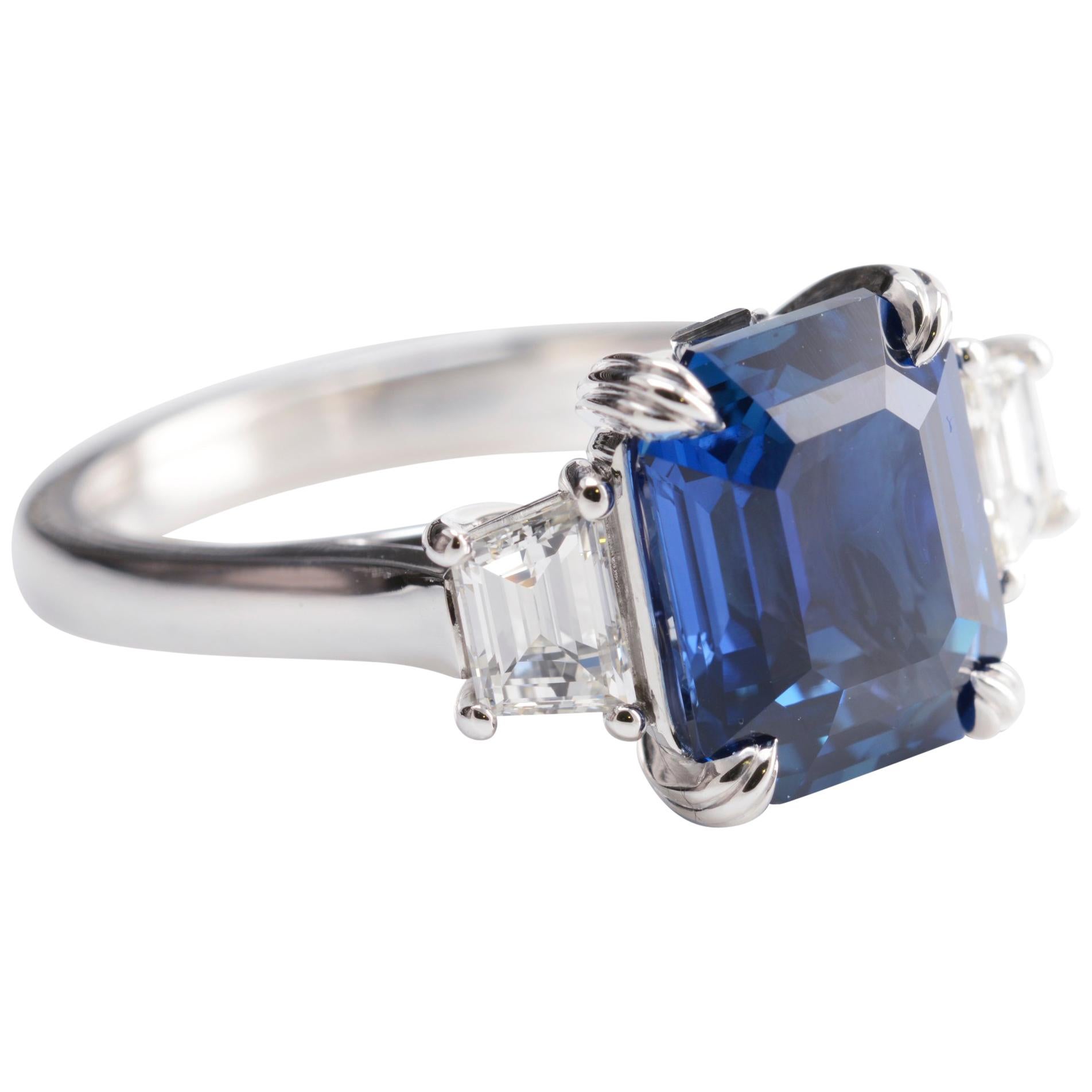 5.12 Carat Natural Emerald Cut Vivid Blue Sapphire and Diamond Three-Stone Ring For Sale