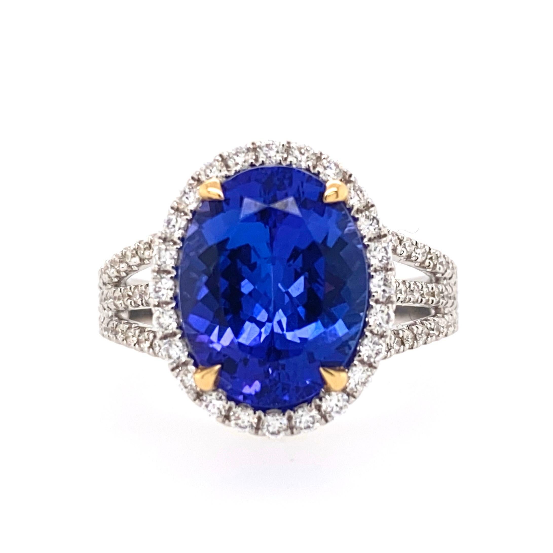 This beautiful cocktail ring features a stunning 5.12 Carat Oval Tanzanite with a Diamond Halo. The Tanzanite is on a Triple Diamond Shank. This Ring is set in 18k White Gold, with 18k Yellow Gold prongs on the center stone. Total Diamond Weight =