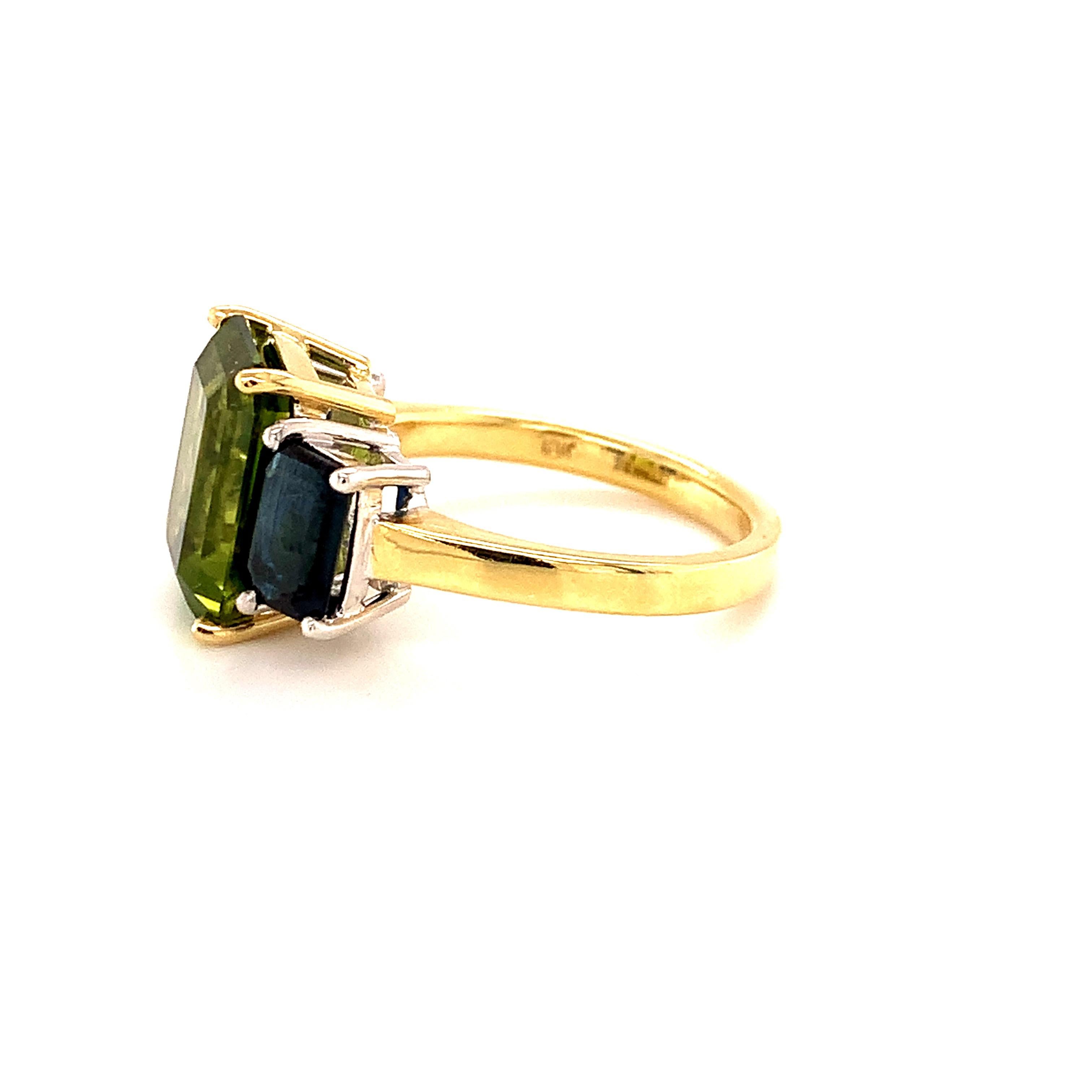 Emerald Cut 5 Carat Peridot and Blue Sapphire Three-Stone Ring in White and Yellow Gold For Sale