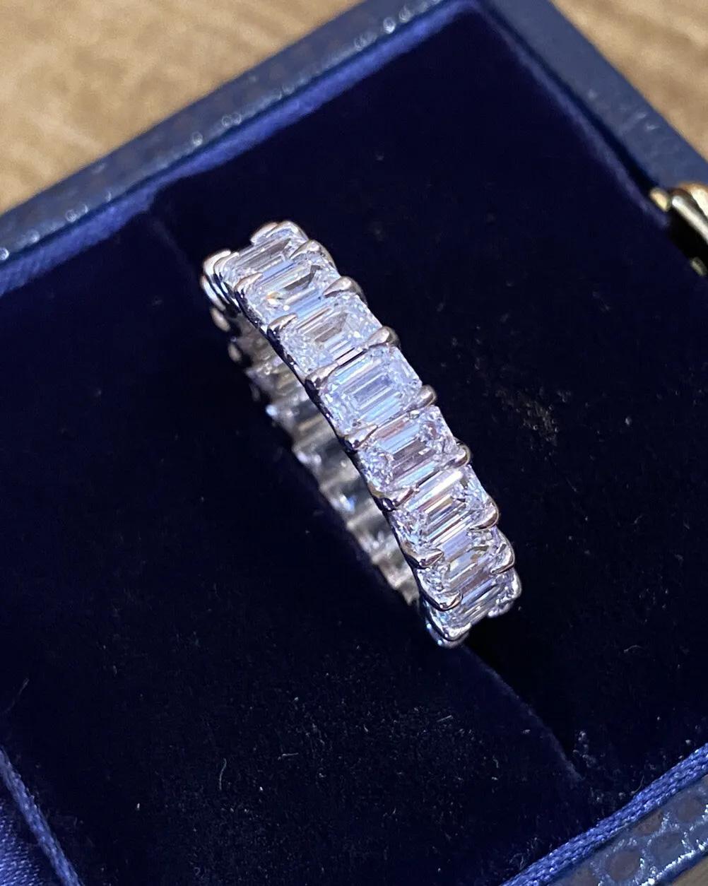 Emerald Cut Diamond Eternity Band Ring 5.12 Carat Total Weight in Platinum.

Diamond Eternity Band Ring features 21 Emerald cut Diamonds, averaging 0.24 carat each, set in Shared Basket Prong Setting in Platinum.

Total diamond weight is 5.12