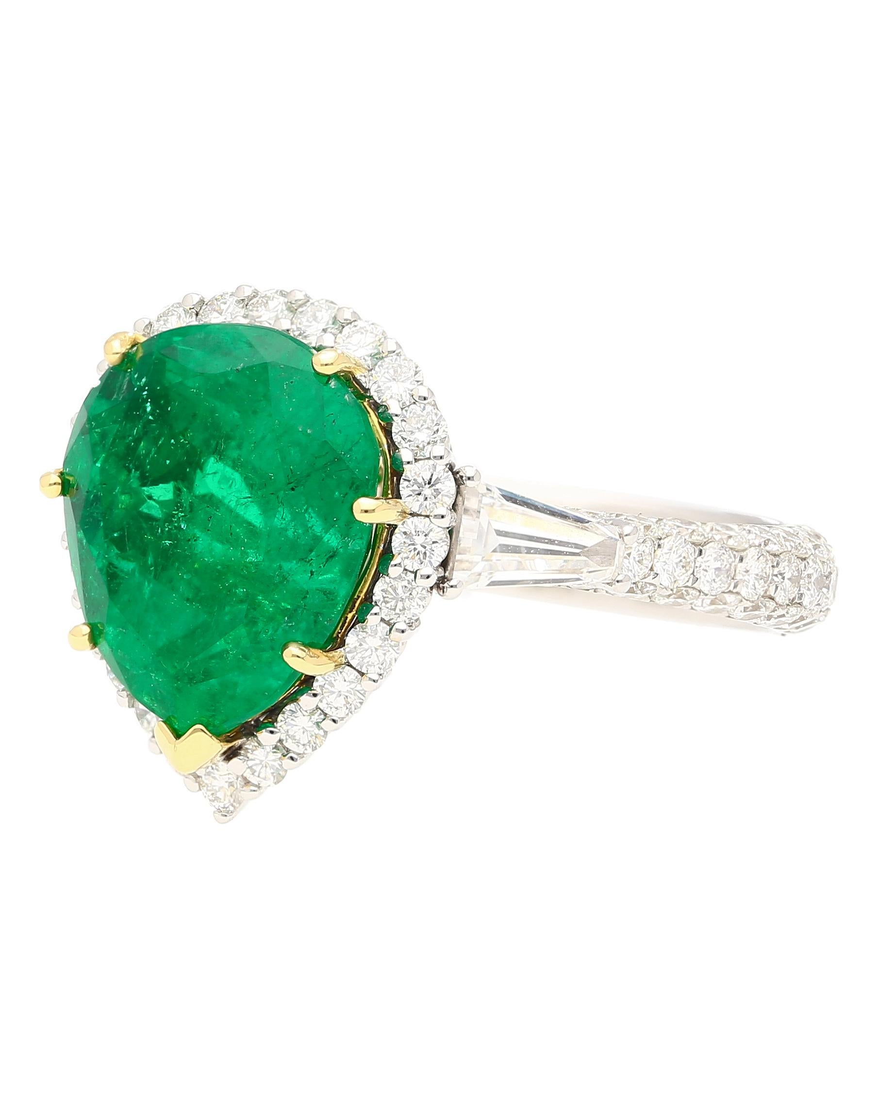 18k white and yellow gold two-tone emerald and diamond ring. Centering a 5.12 carat pear cut Colombian emerald of vivid green color. GRS certified. Flanked by two baguette cut diamond side stones and 181 round cut diamonds mounted on the shank.

The
