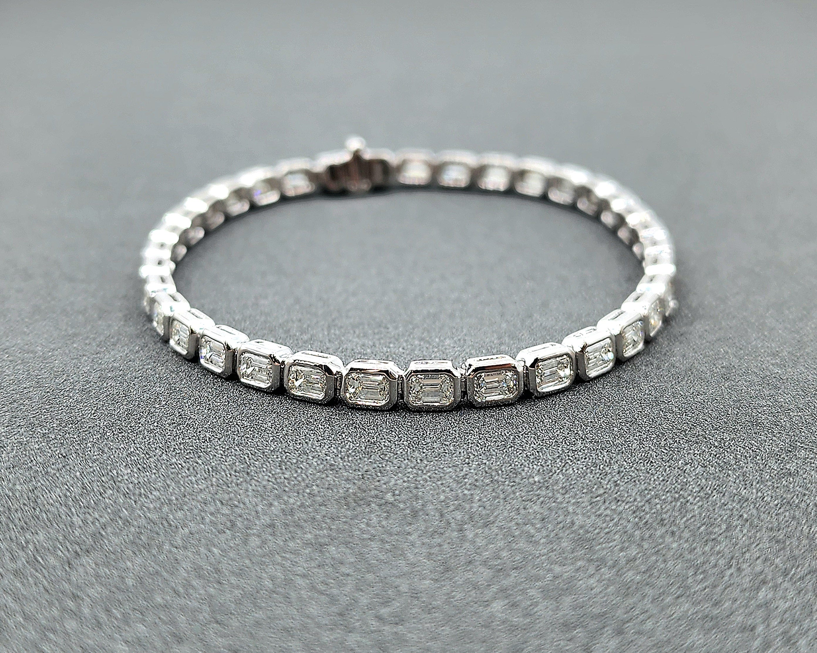 This exquisite tennis bracelet is a true masterpiece. Featuring 5.12 carats of emerald-cut diamonds, each stone is of F/G color and VS1/VS2 clarity, radiating a brilliant white hue. The diamonds are meticulously set in luxurious platinum, creating a