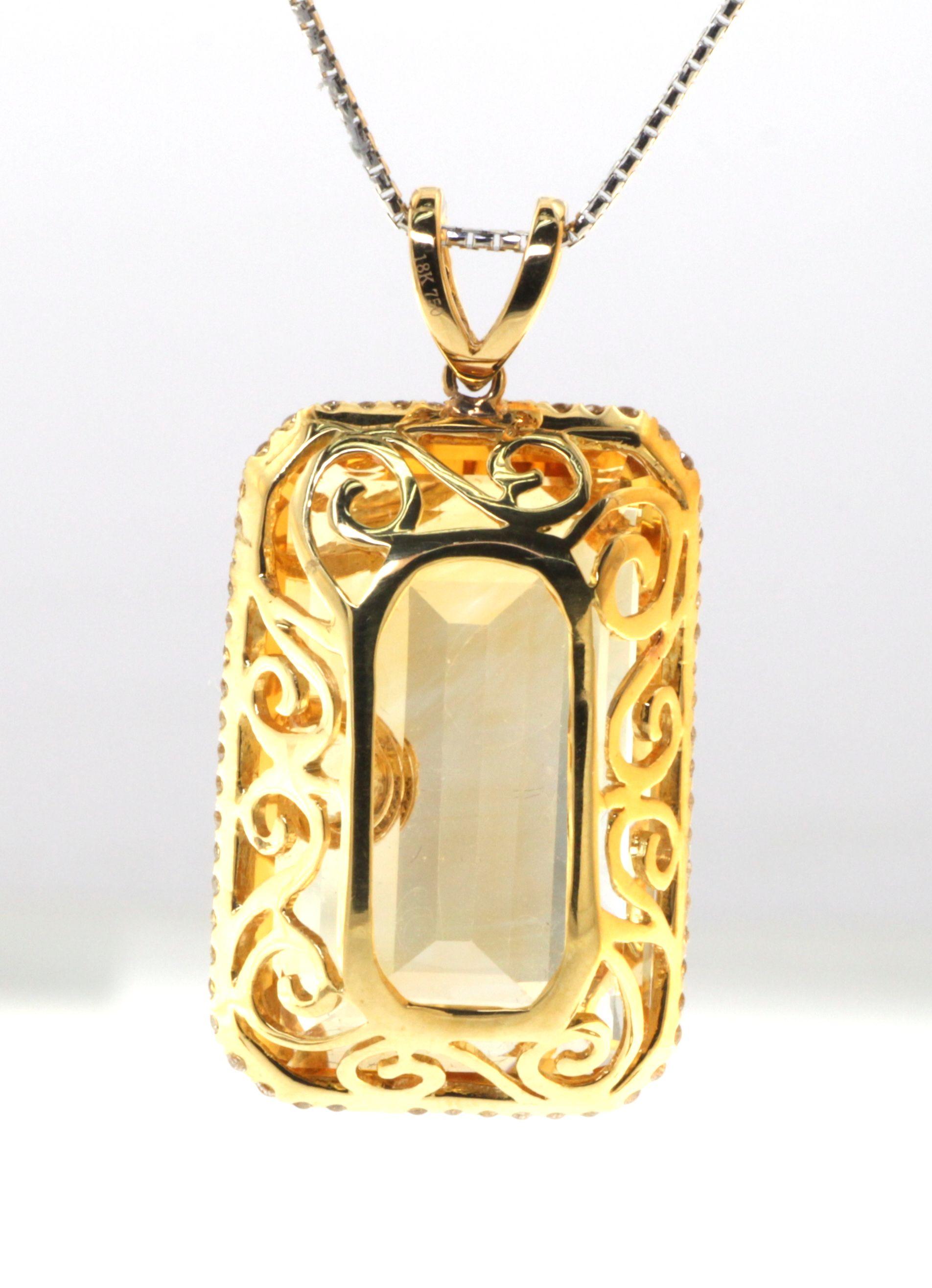 This stunning pendant is sure to turn heads with its bold and beautiful design. The centerpiece of the pendant is a magnificent 51.22 carat emerald cut citrine that is sure to catch the light and shimmer beautifully. The citrine is accented with