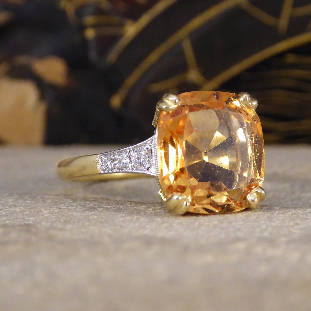 Behold the exquisite beauty of our 5.12ct Imperial Topaz Ring, a true masterpiece that seamlessly combines the allure of an antique design with the elegance of contemporary craftsmanship. The stunning 5.12ct Imperial Topaz, held securely in a