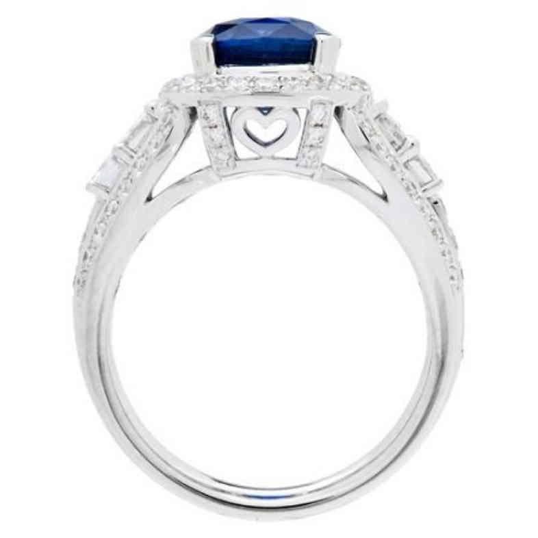 A one of a kind cushion cut Ceylon Sapphire, flanked by round brilliant Diamonds and round brilliant Diamonds in an 18 Karat white Gold AMORO heart prong design.