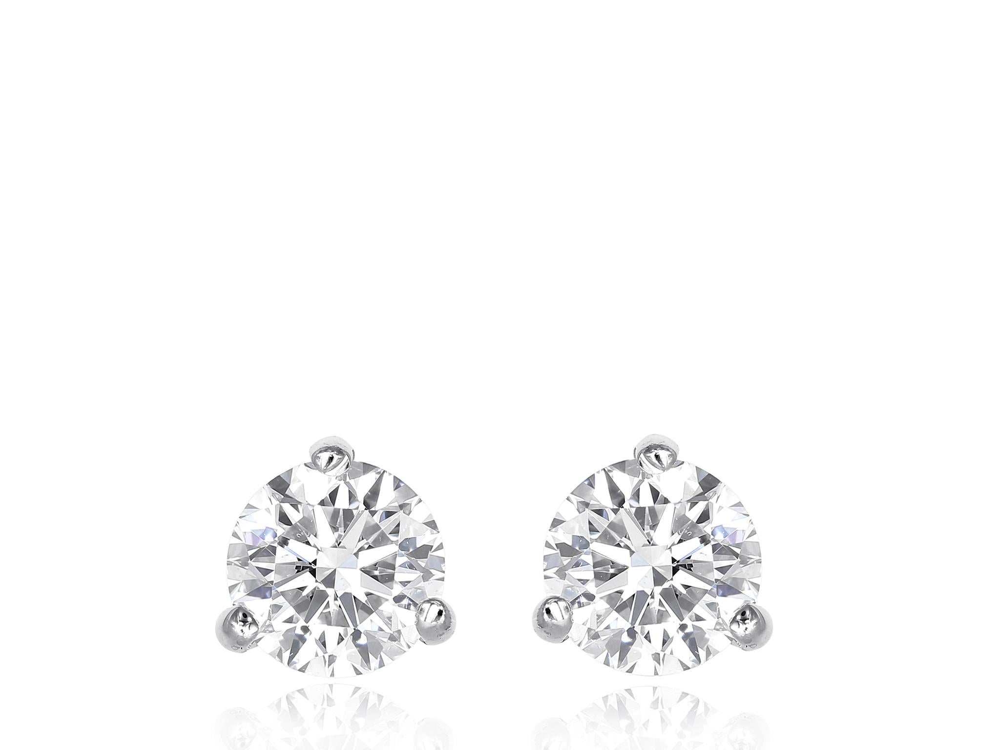 Diamond stud earrings consisting of two round brilliant cut diamonds with a total weight of 5.14 carats, with a color and clarity of H-I SI2 respectfully, set in a white gold three prong martini mounting with friction post.