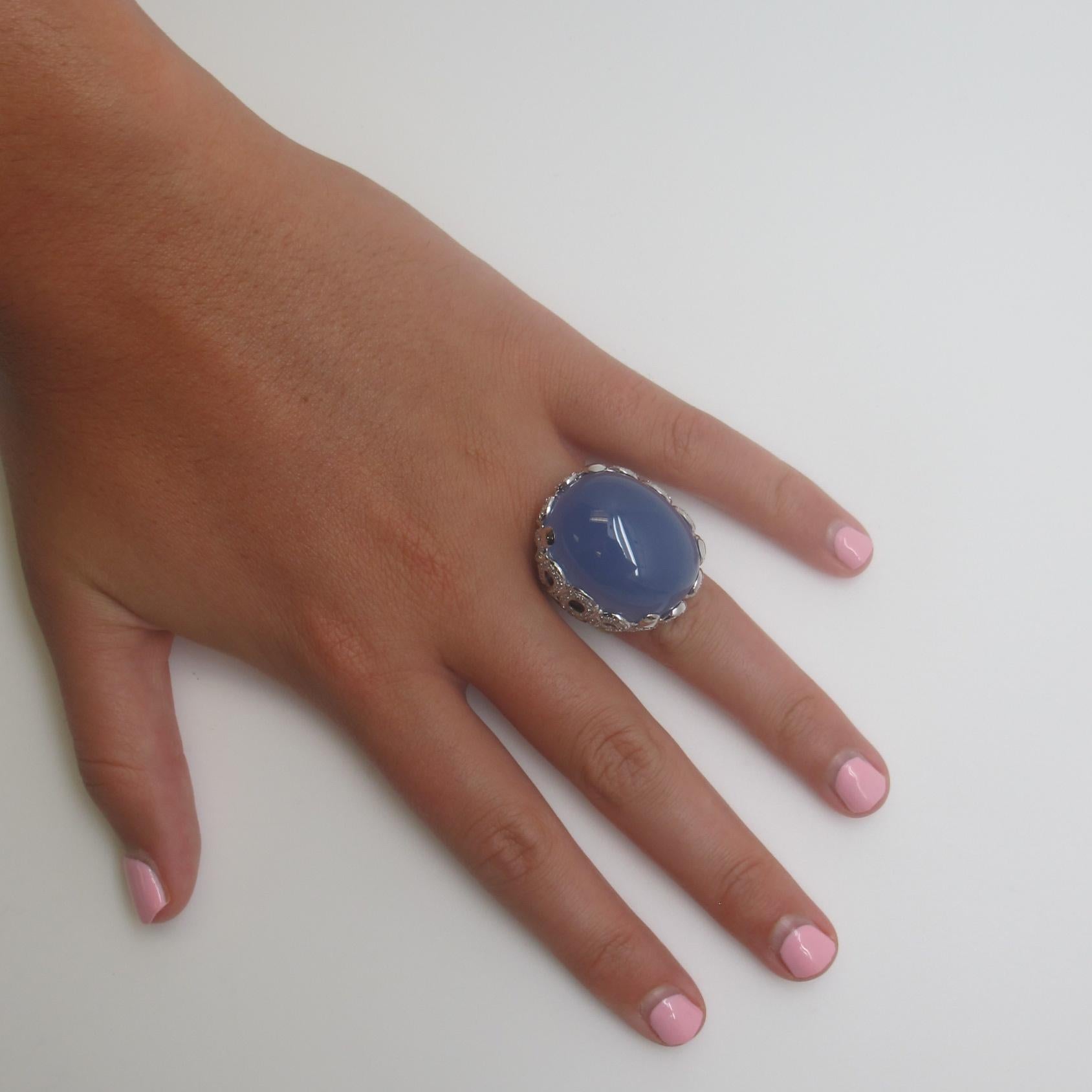 Giant lavendar- blue chalcedony (51.41 carats) and 154 round brilliant cut diamonds (0.73 carats total)  are combined in this beautiful  18k white gold ring.  A lavendar chalcedony cabochon of this size and quality is rare to find. This ring packs a