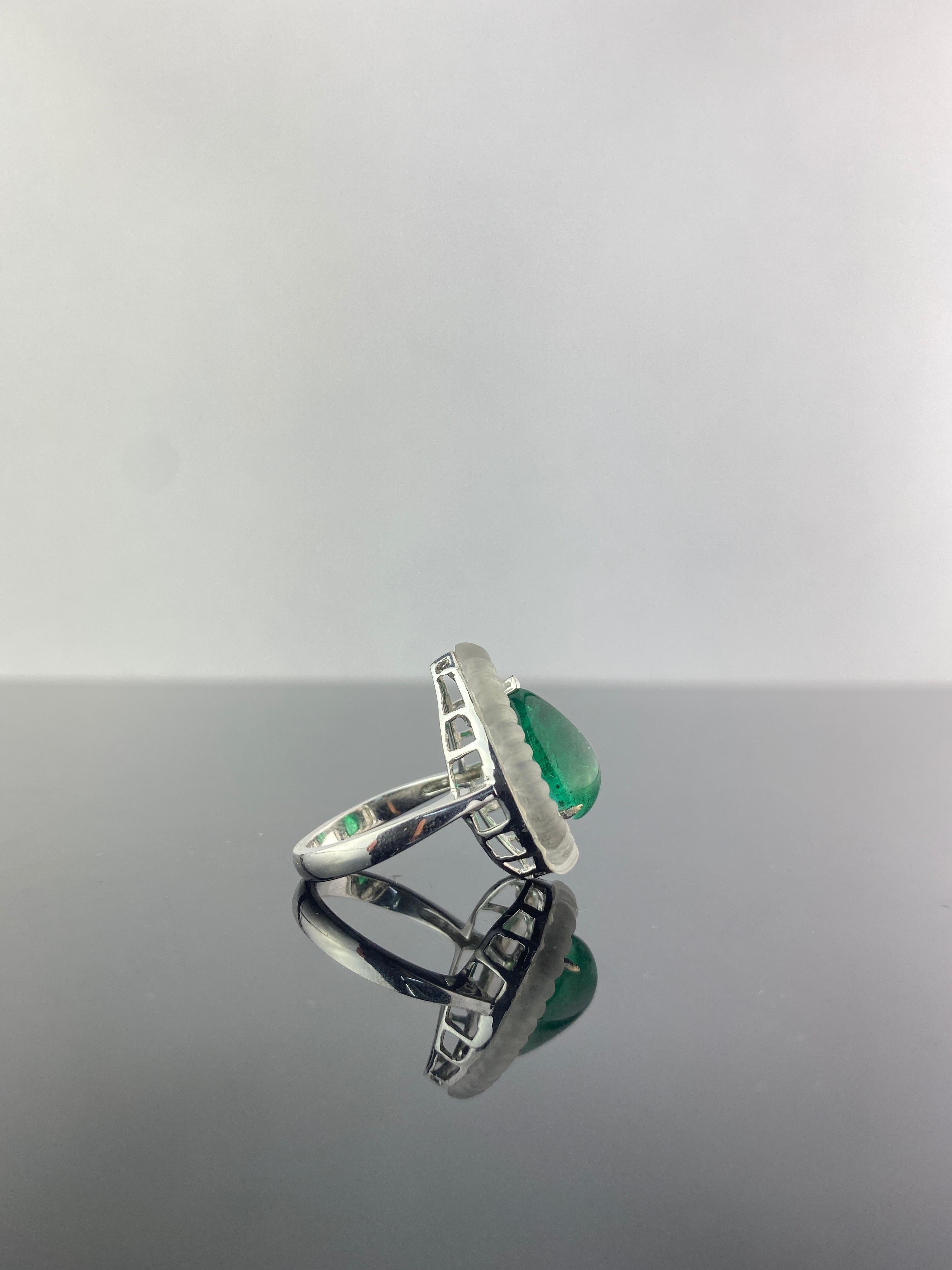 A gorgeous art-deco style looking cocktail ring, with 5.15 carat Emerald Cabochon (transparent, with an ideal color and great luster), outlined with 0.36 carat White Diamonds and intricately cut Rock Crystal. The ring is made in 8.5 grams of solid