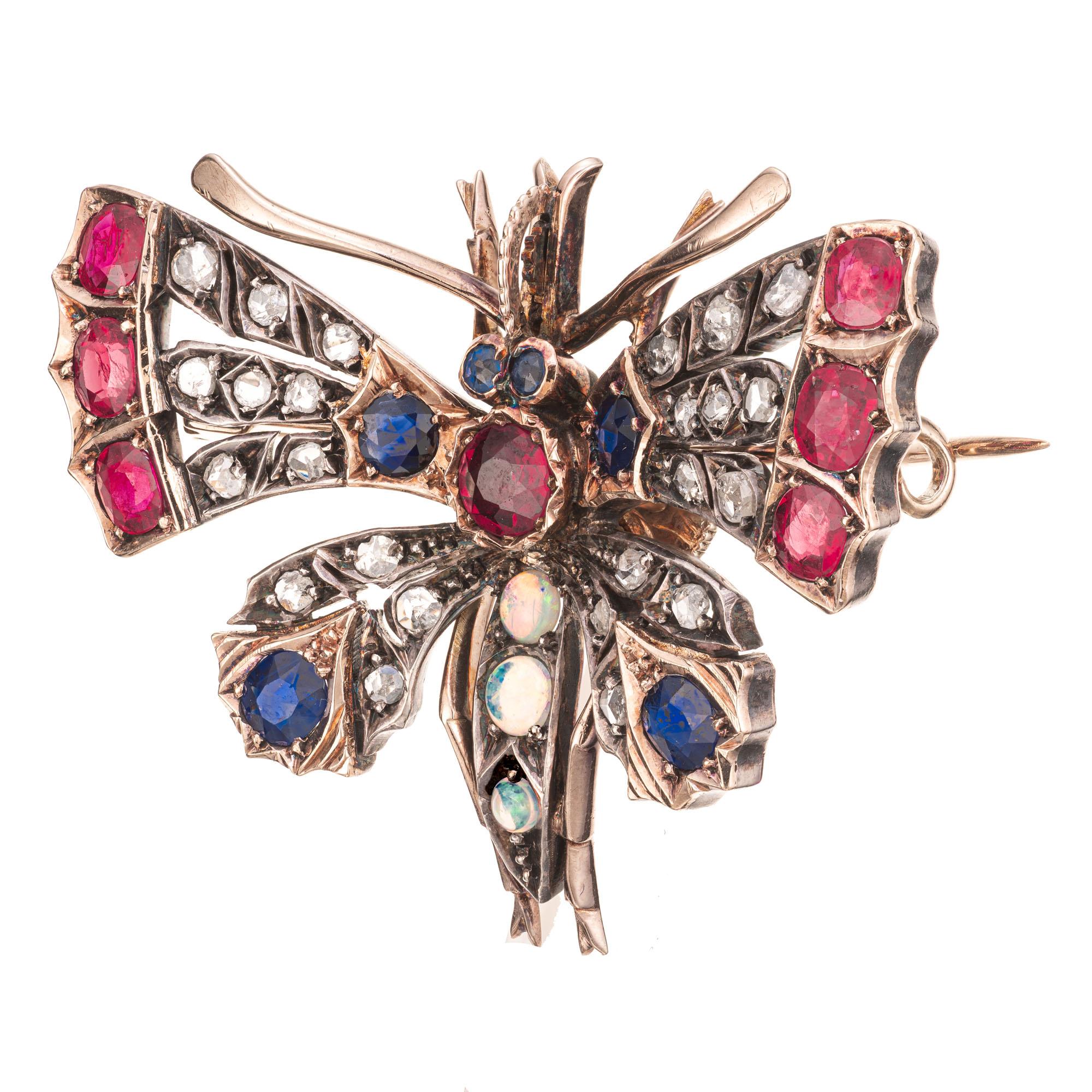 Mid 1880's Victorian moth Brooch. Set with rubies, diamonds, sapphires and opals in a 11-12 yellow gold and silver setting. Pin finding unscrews from the back. Tested 11k to 12k  gold and silver.  Diamonds and Opals are set in silver. 

6, 4.3mm