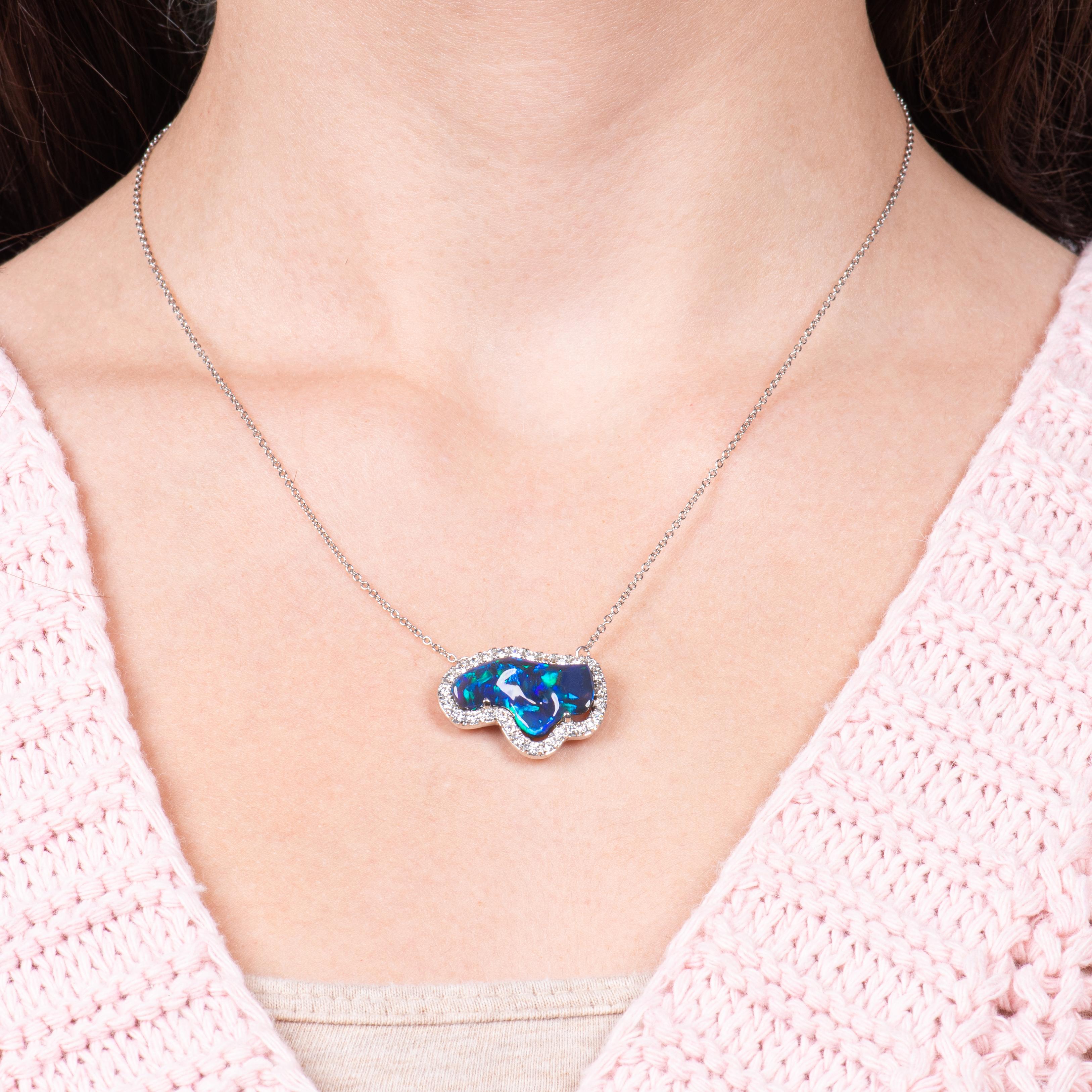 This pendant features a 5.15ct Lightning Ridge Australian opal set in a platinum necklace and accented with 1.00ctw in round cut diamonds forming the halo.