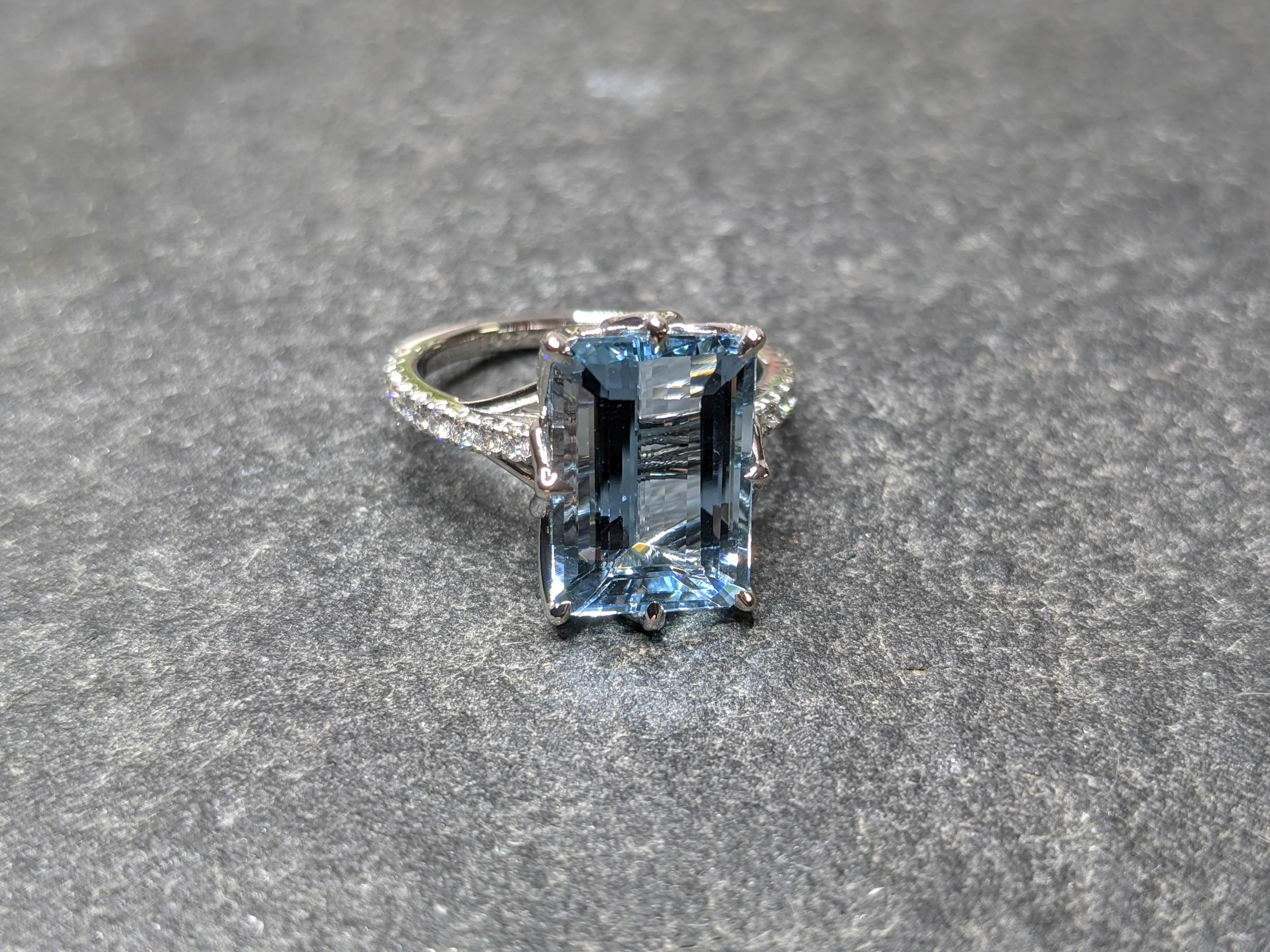 5.61 carat Aquamarine, emerald cut, very high quality color, eye clean gem, with a pave' of bright white diamonds F/G color, of approximately  total carat weight of 0.35 carat, set in a Platinum 950 floral-lotus motive,  manufactured with the best