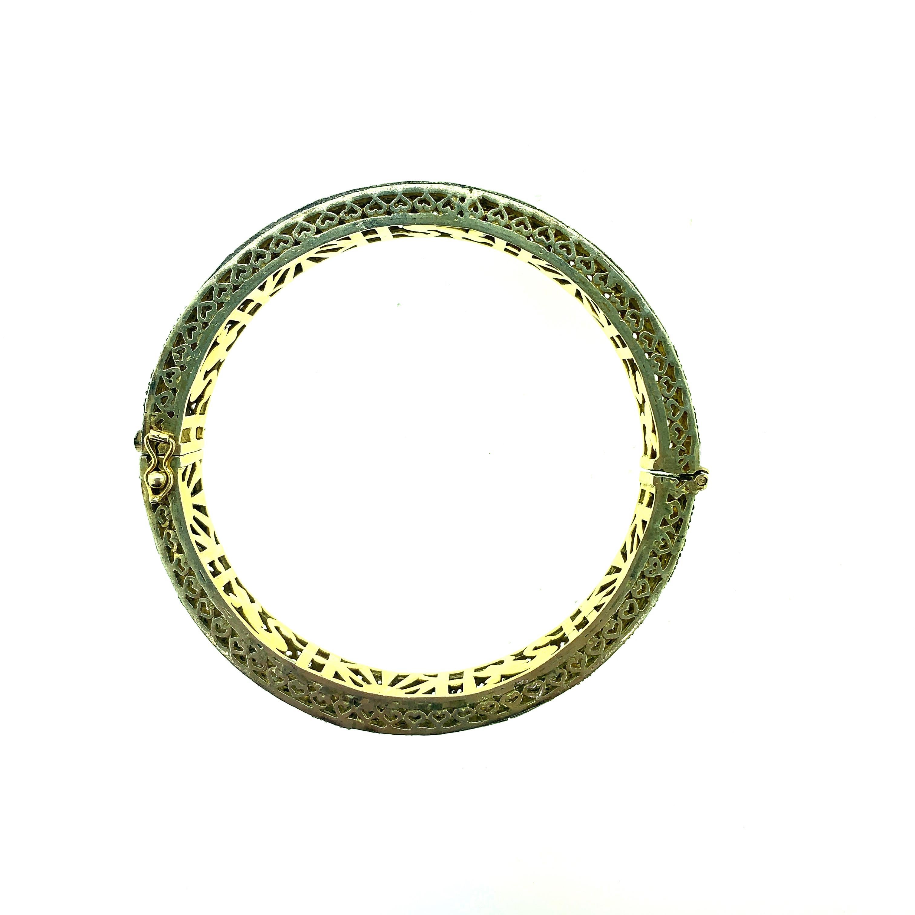 5.16 ct Old Mine Cut (Polki Diamond) Bangle set in Oxidized Sterling Silver with pure 14K Gold. The bangle diameter is 2.6 Inch with a row of Old Mine Cut Diamond in the center and surrounded by lines of pave diamond on each side. It is a