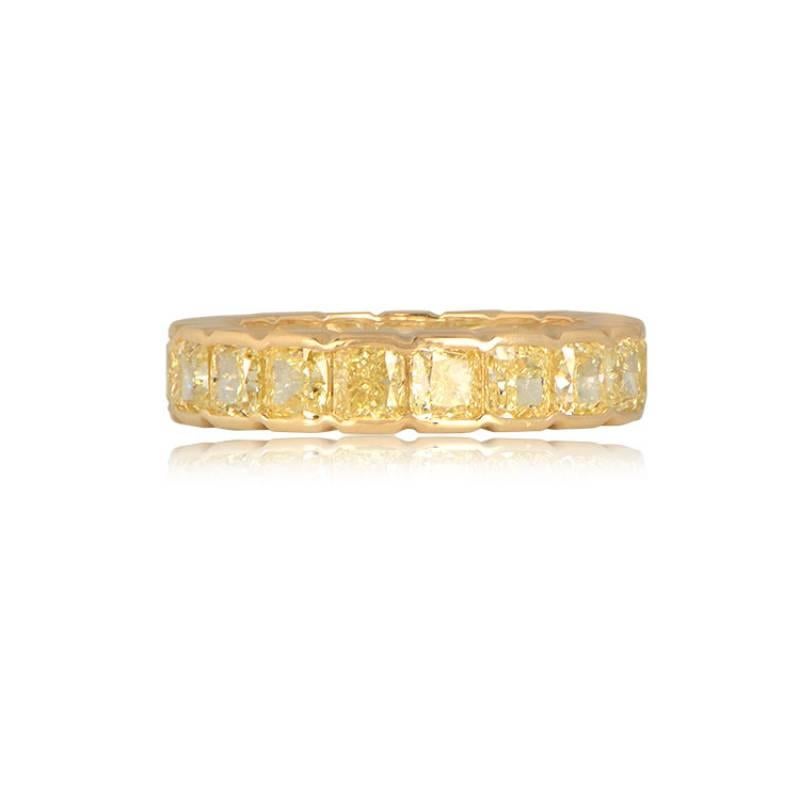 A breathtaking diamond and 18k yellow gold band showcasing an eternity of fancy yellow diamonds, totaling approximately 5.16 carats, with VS clarity. The diamonds are elegantly bezel set using half-bezels, adding a unique and sophisticated touch to