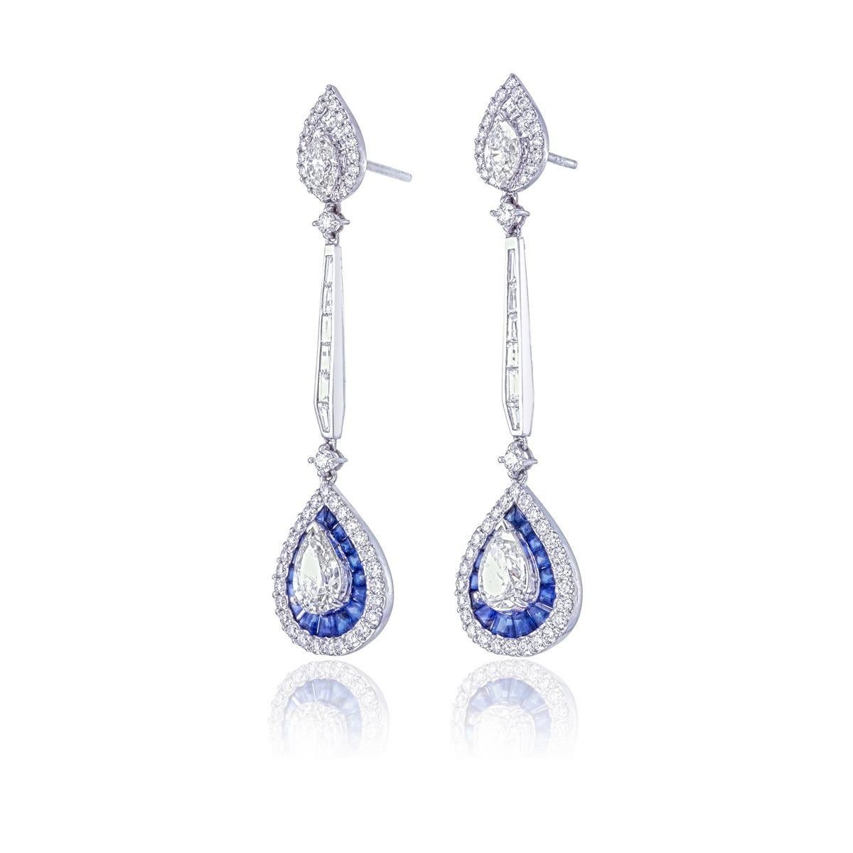 Presenting an exquisite pair of earrings from Rewa Jewelry, featuring stunning 5.17-carat diamond and blue sapphire earrings 

The center stones are pear-shaped diamonds totaling 2.05 carats, surrounded by an additional 3.12 carats of round,