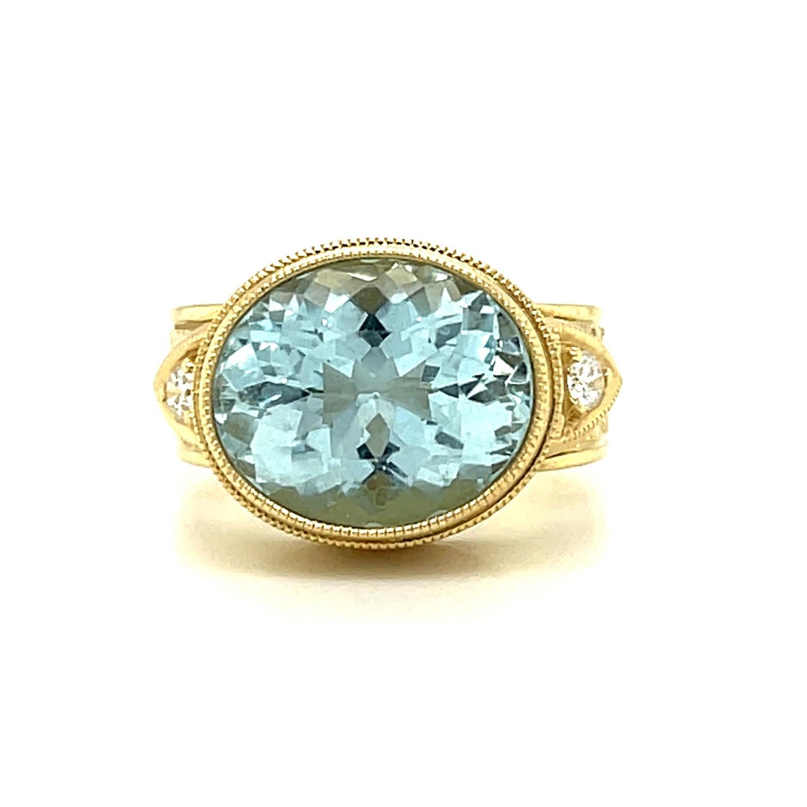 This gorgeous, handmade 18k yellow gold ring features a sparkling aquamarine with beautiful, bright color! The aquamarine is an oval shape, weighs 5.17 carats, and has been oriented to sit 