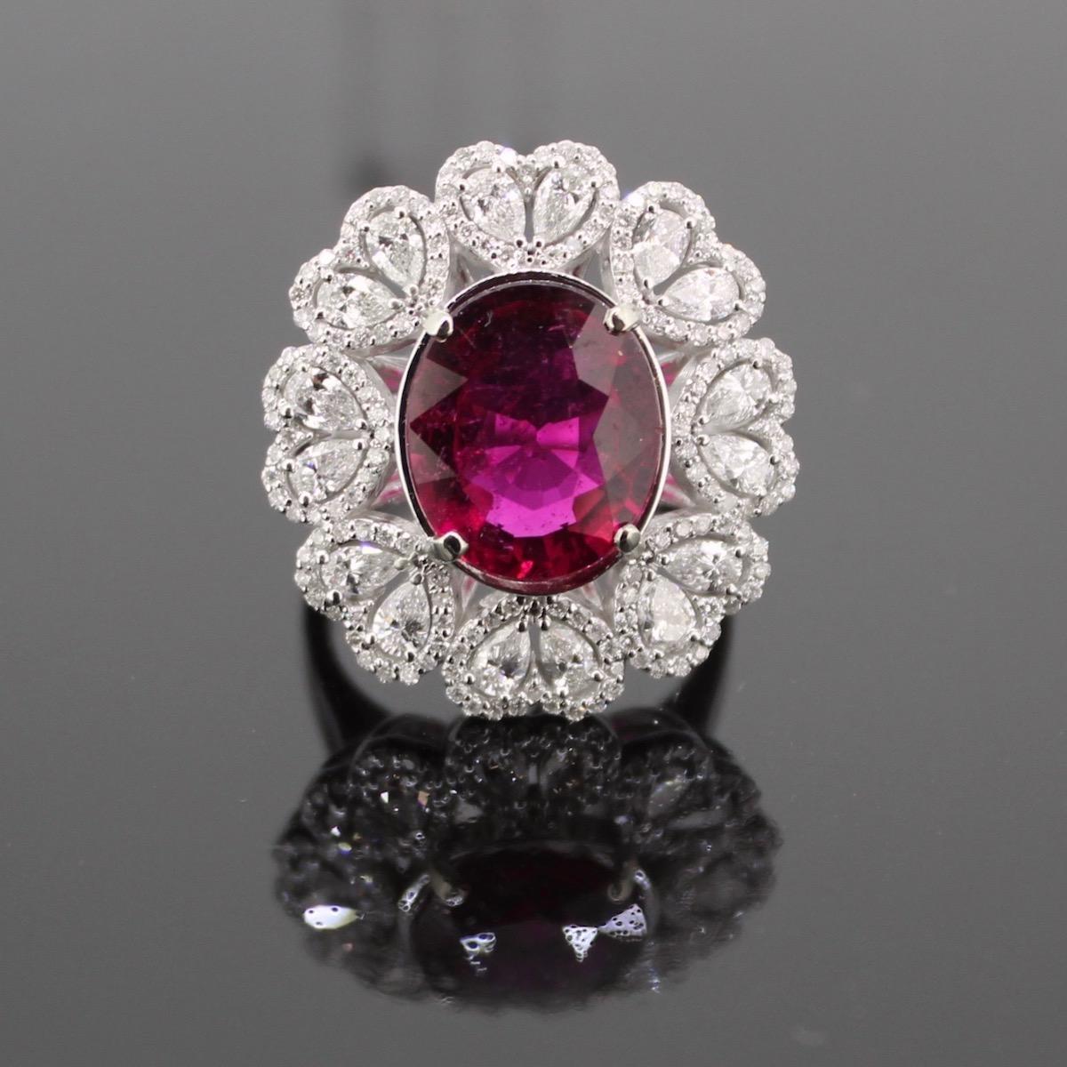 Weight:	10.75gr


Metal:		18kt white Gold


Stones:	1 Rubellite Tourmaline
•	Cut:	Oval
•	Carat weight:	5.17ct 


Other Stones:	16 Diamonds				152 Diamonds
•	Cut:	Pear						Round
•	Total carat weight: 	1.30ct approximately			0.80ct