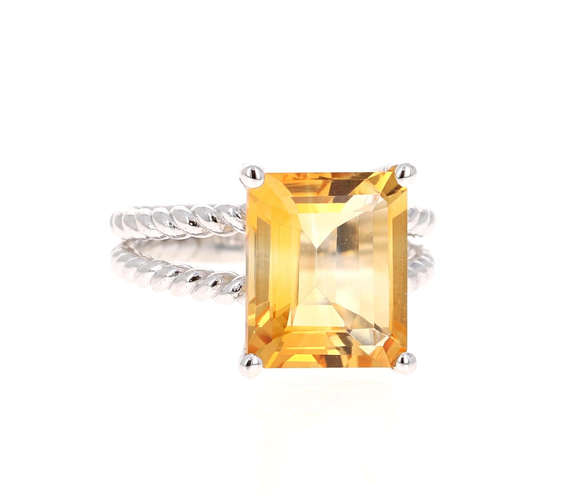 This beautiful, designer inspired ring has a bright and vivid Emerald Cut Citrine Quartz in the center that weighs 5.18 carats. 
The setting is beautifully crafted in 14K White Gold and weighs approximately 5.1 grams.
The ring is a size 7 and can be