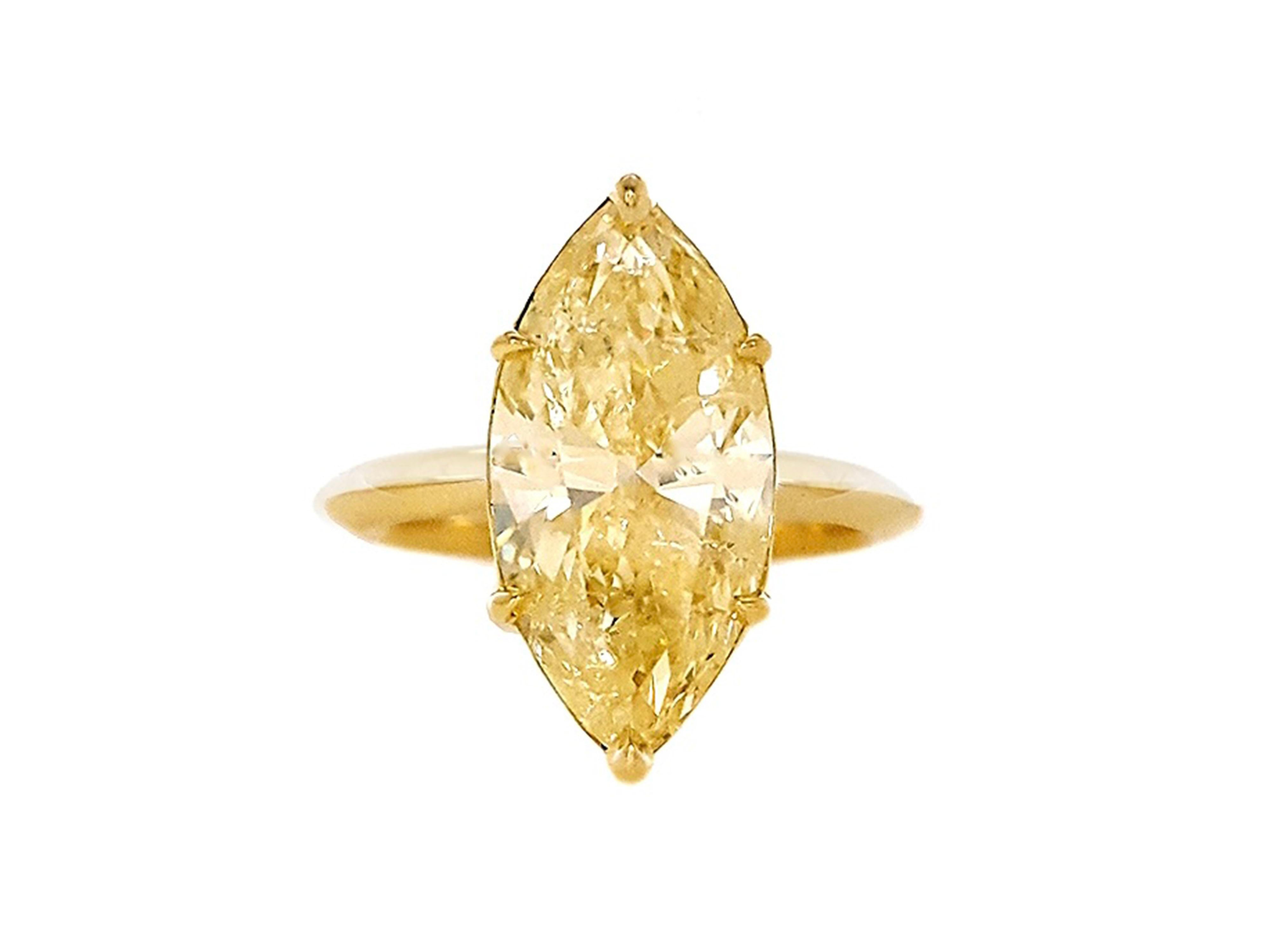 Absolutely stunning engagement ring style features a 5.18 Carat Fancy Yellow, Marquee Cut Diamond that sparkles and shines with every movement. Set in 18K Gold Engagement Ring certified by GIA. The handcrafted setting adds a beautiful yellowish