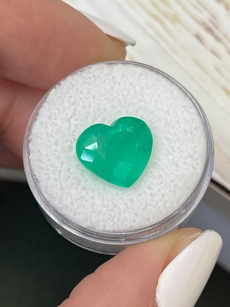 Stone: Emerald
Weight: 5.18-carats
Shape: Heart Cut
Clarity: Transparent
Luster: Very Good
Color: Medium Green
Measurements: 12.12mm x 9.85mm x 7.53mm
Geographic Origin: Colombia
Treatment: Natural, Oiling

Comments: Due to their growth conditions