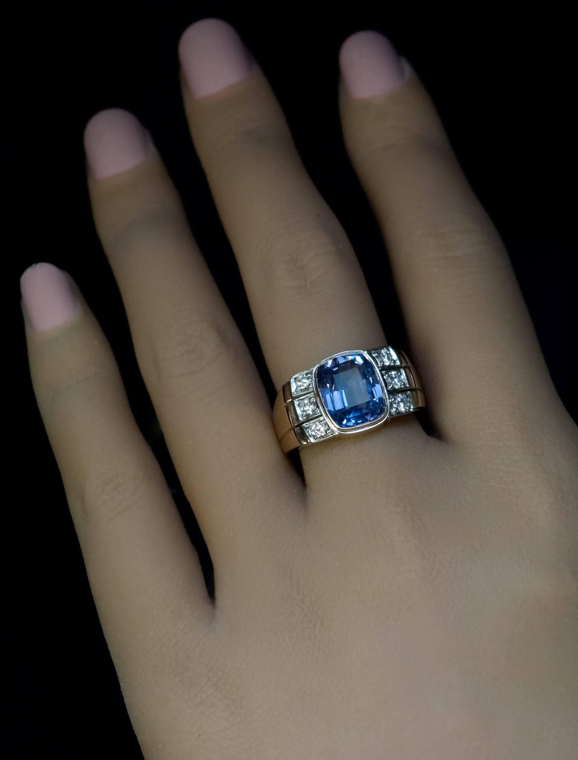 Circa 1970  The ring is crafted in yellow and white 14K gold. It features a 5.18 carat unheated blue sapphire from Ceylon. The sapphire is accented by six small diamonds (F color, VVS2-VS1 clarity).  The ring is accompanied by the ALGT (Antwerp,