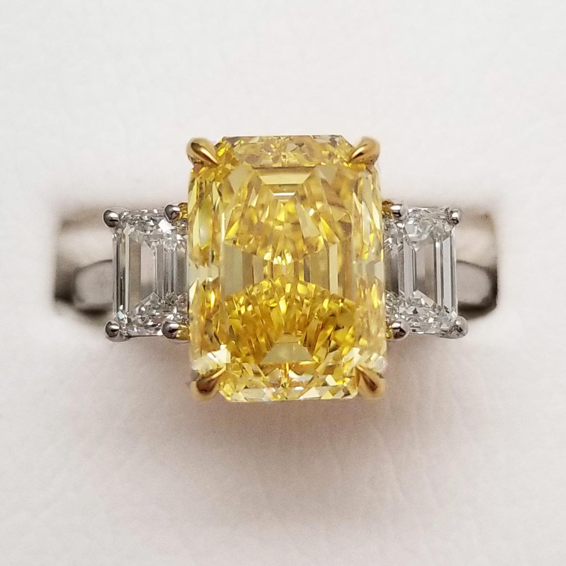 Modern 5.18 ct Emerald Cut Fancy Vivid Yellow Diamond 3 Stone Engagement Ring GIA 18k  For Sale