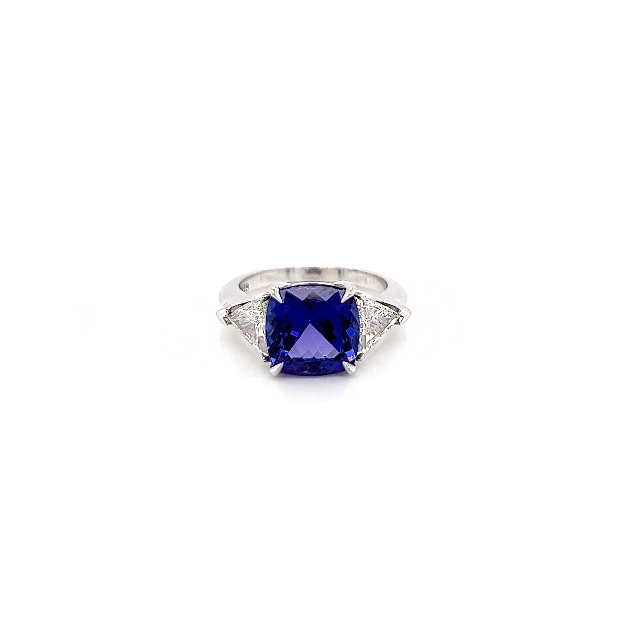 5.18 Total Carat Tanzanite and Diamond Three Stone Ladies Ring

-Metal Type: Platinum
-4.28 Carat Cushion Cut Natural AAA Quality Tanzanite 
-0.90 Carat Trillion Cut Natural side Diamonds. F-G Color, VS1-VS2 Clarity 

-Size 6.0

Made in New York City