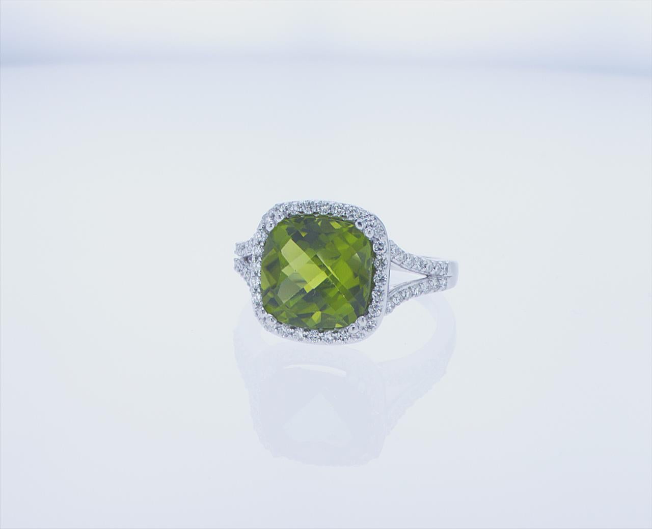 5.18ct Cushion Peridot with 0.43ct Total Weight of G/H Color, VS Clarity Accent Diamonds. 14k White Gold Mounting.
