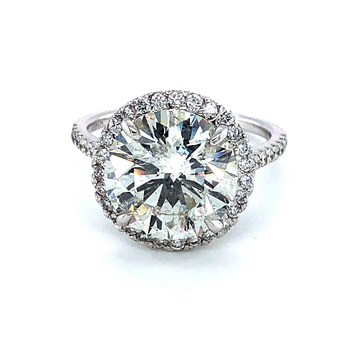 This gorgeous Diamond Ring is is just full of brilliancy. The diamond in the center weighs 5.18 carat with H-I color and fine I1, but is clean to the naked eye. The diamond sparkles from every direction, really just a gorgeous diamond with diamond