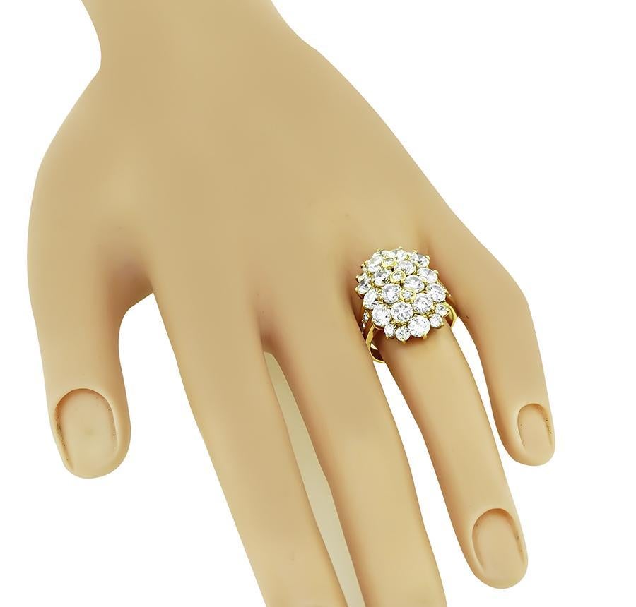 This is a stunning 18k yellow gold ring. The ring is set with sparkling round cut diamonds that weigh approximately 5.18ct. The color of these diamonds is F-G with VS clarity. The top of the ring measures 22.5mm by 16mm. The ring is stamped K18 5.18