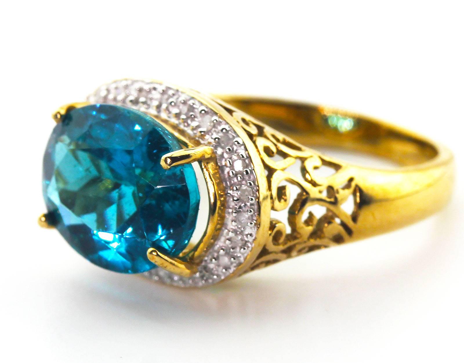This flawless glittering 5.2 Carat unique natural blue Apatite from Madagascar is adorned with tiny little sparkling diamonds set in 10 KT yellow gold ring.  The Apatite is 12 mm x 10 mm and the ring is a size 7.5 sizable.  