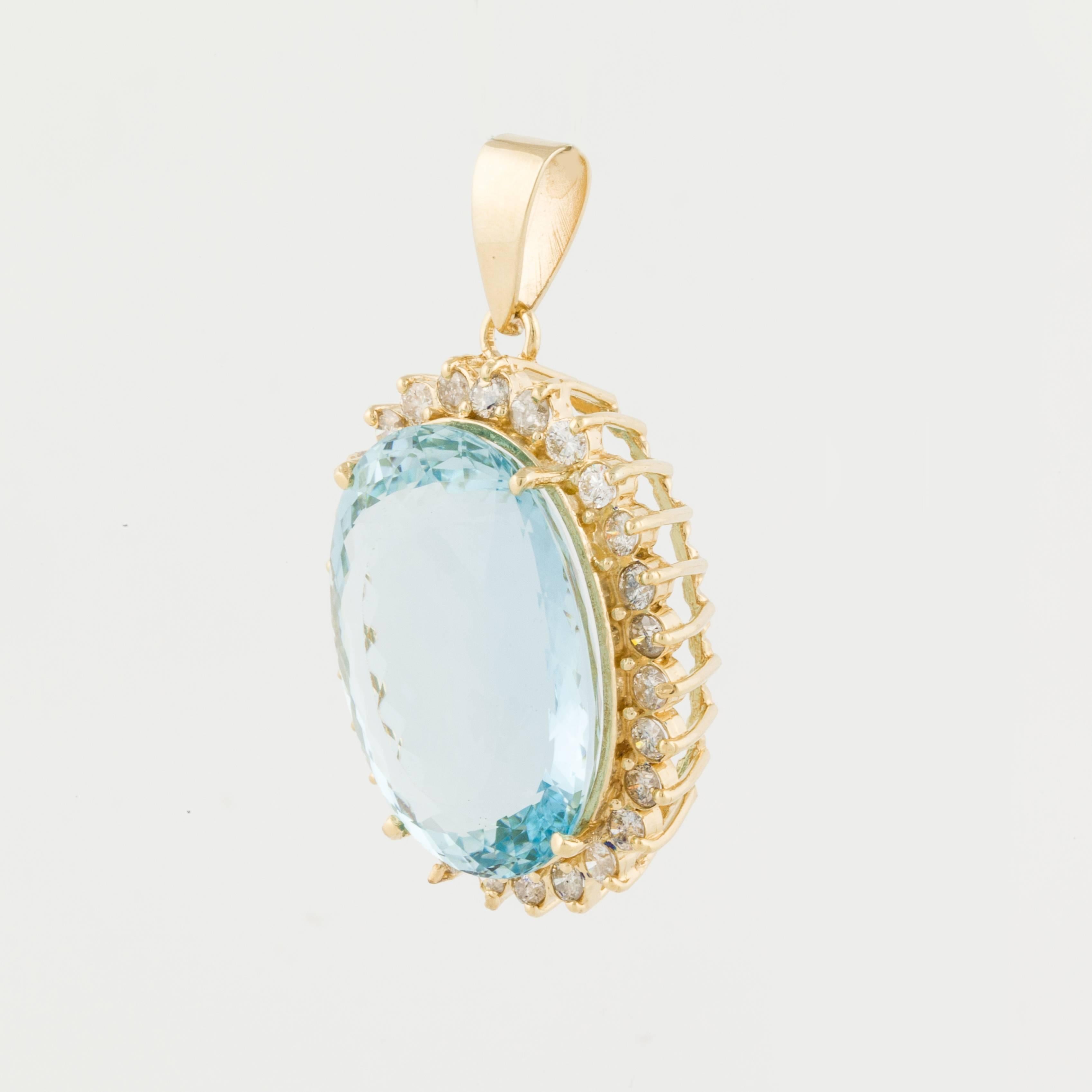Pendant in 18K yellow gold featuring a large 52.93 carat aquamarine framed by round diamonds. There are 27 round diamonds that total 2.20 carats,  G-I color and SI-1 clarity.  The pendant measures 1 1/2 inches long and 1 1/8 inches wide.  
